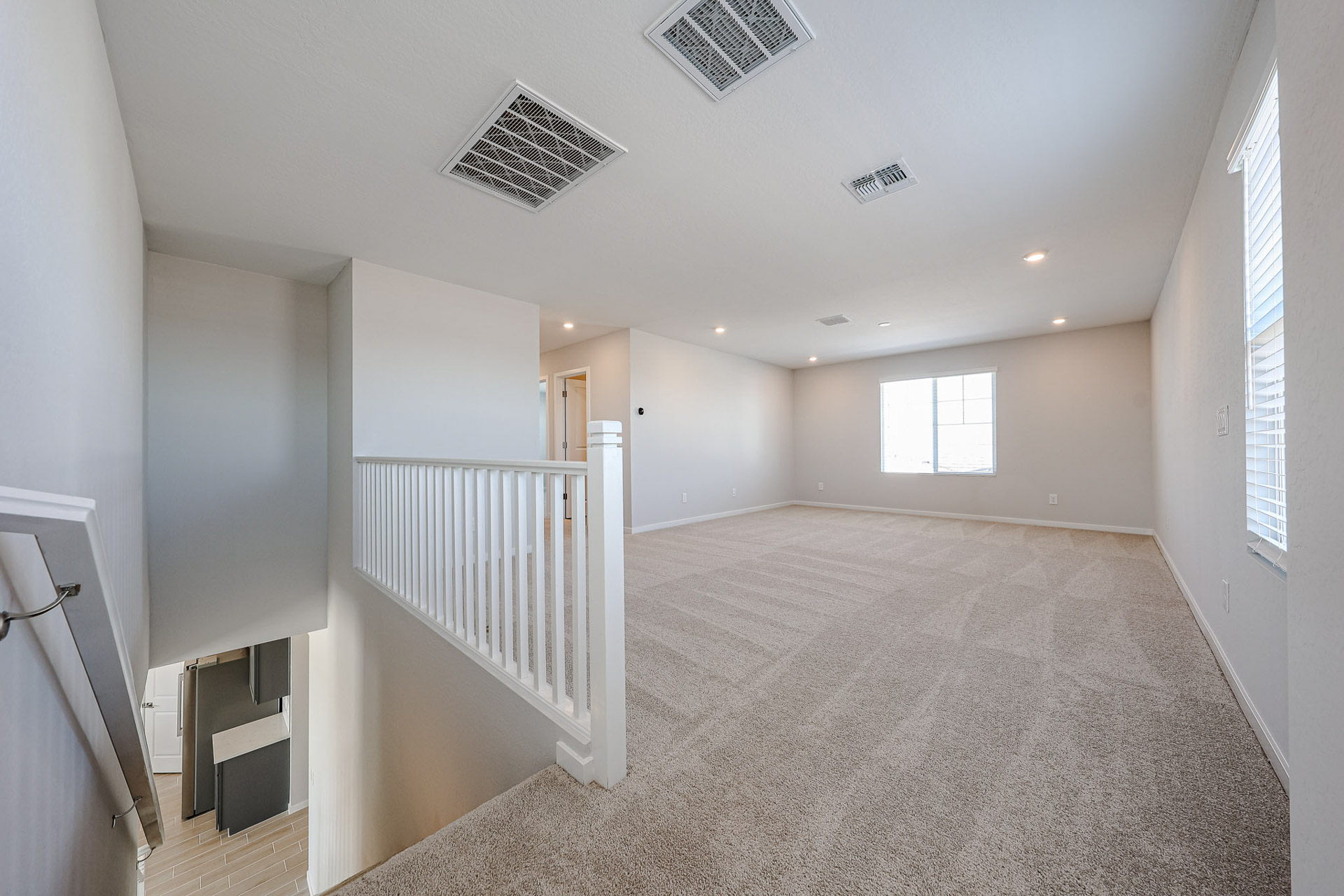 A room with a white railing and a white railing.