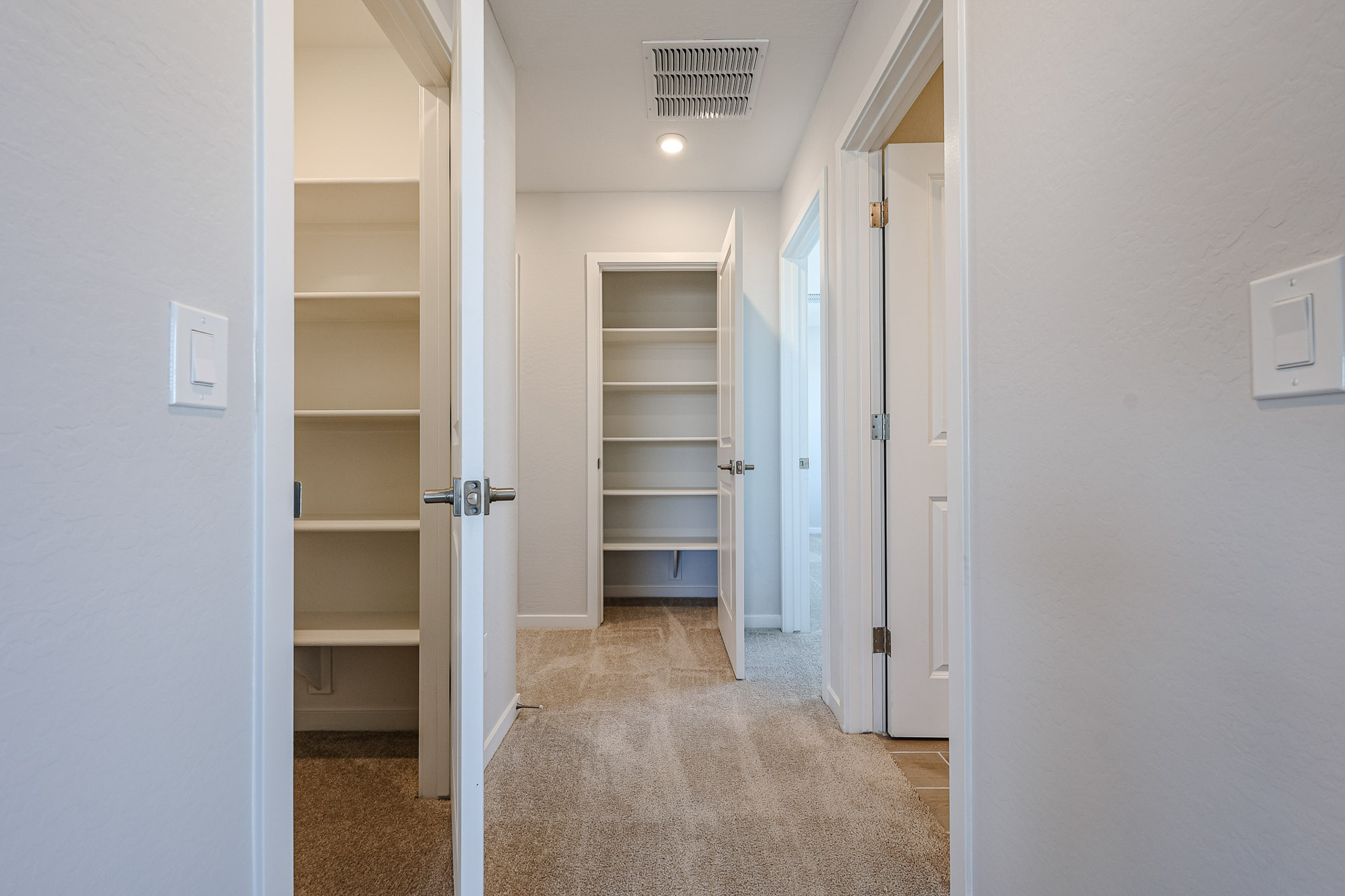 A hallway with white doors.