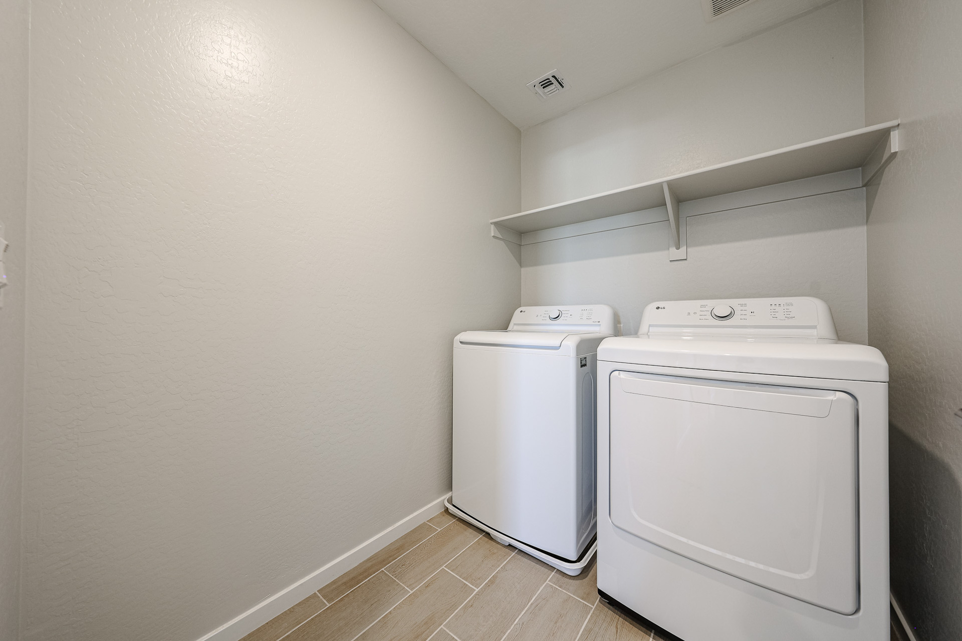 A washing machine and dryer in a room.