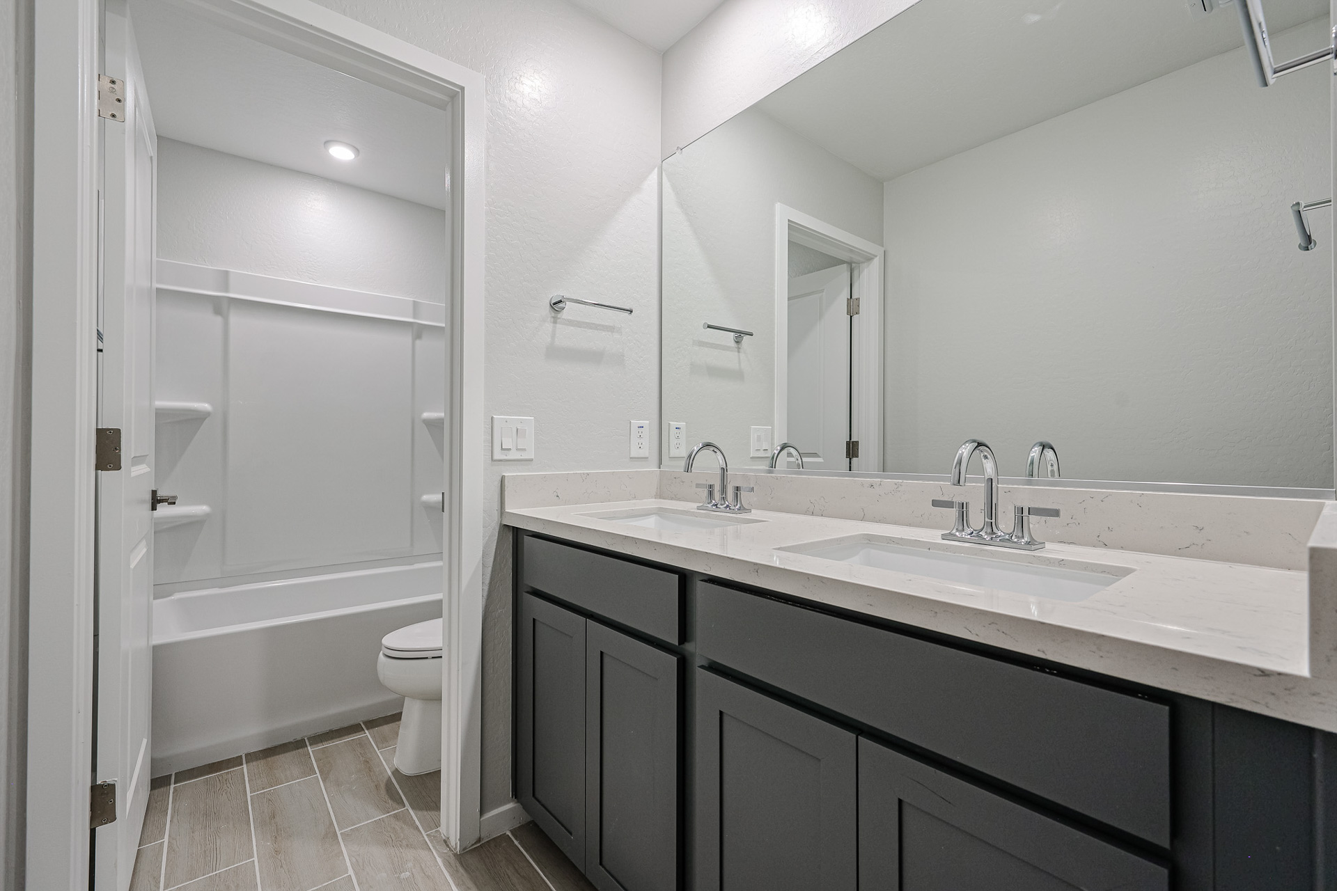 A bathroom with a tub sink and toilet.