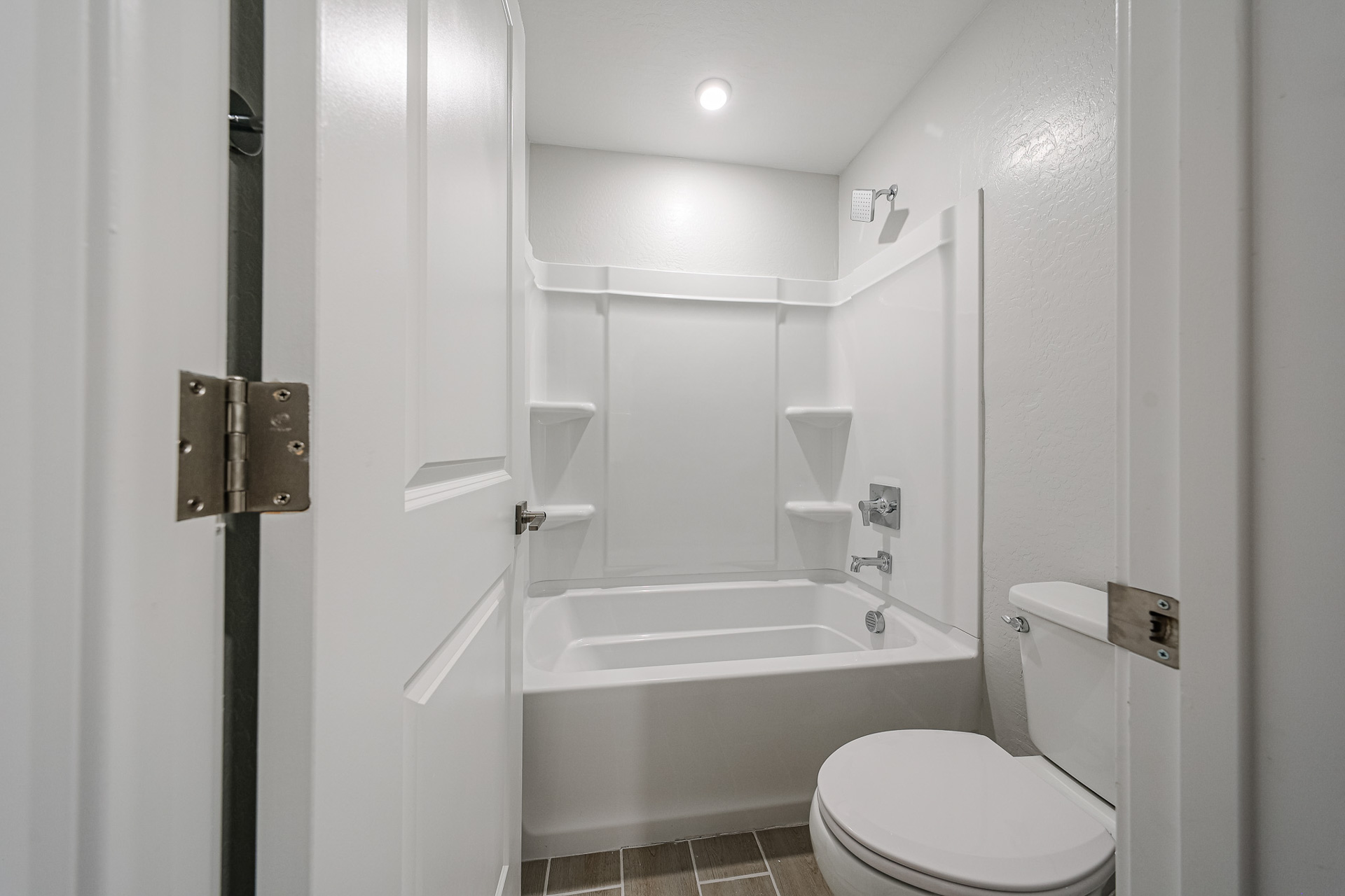 A bathroom with a tub toilet and sink.