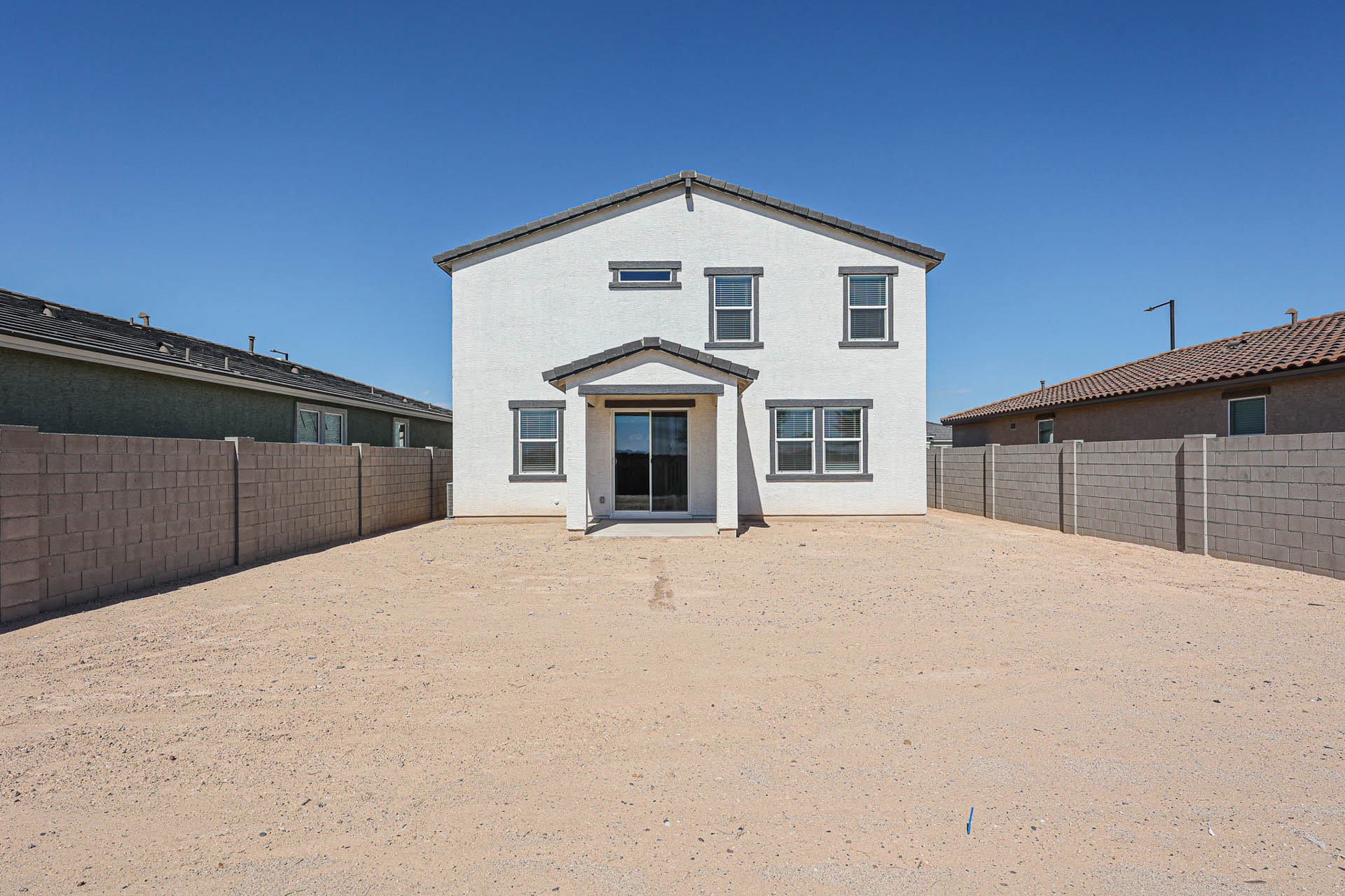 A white house with a garage.
