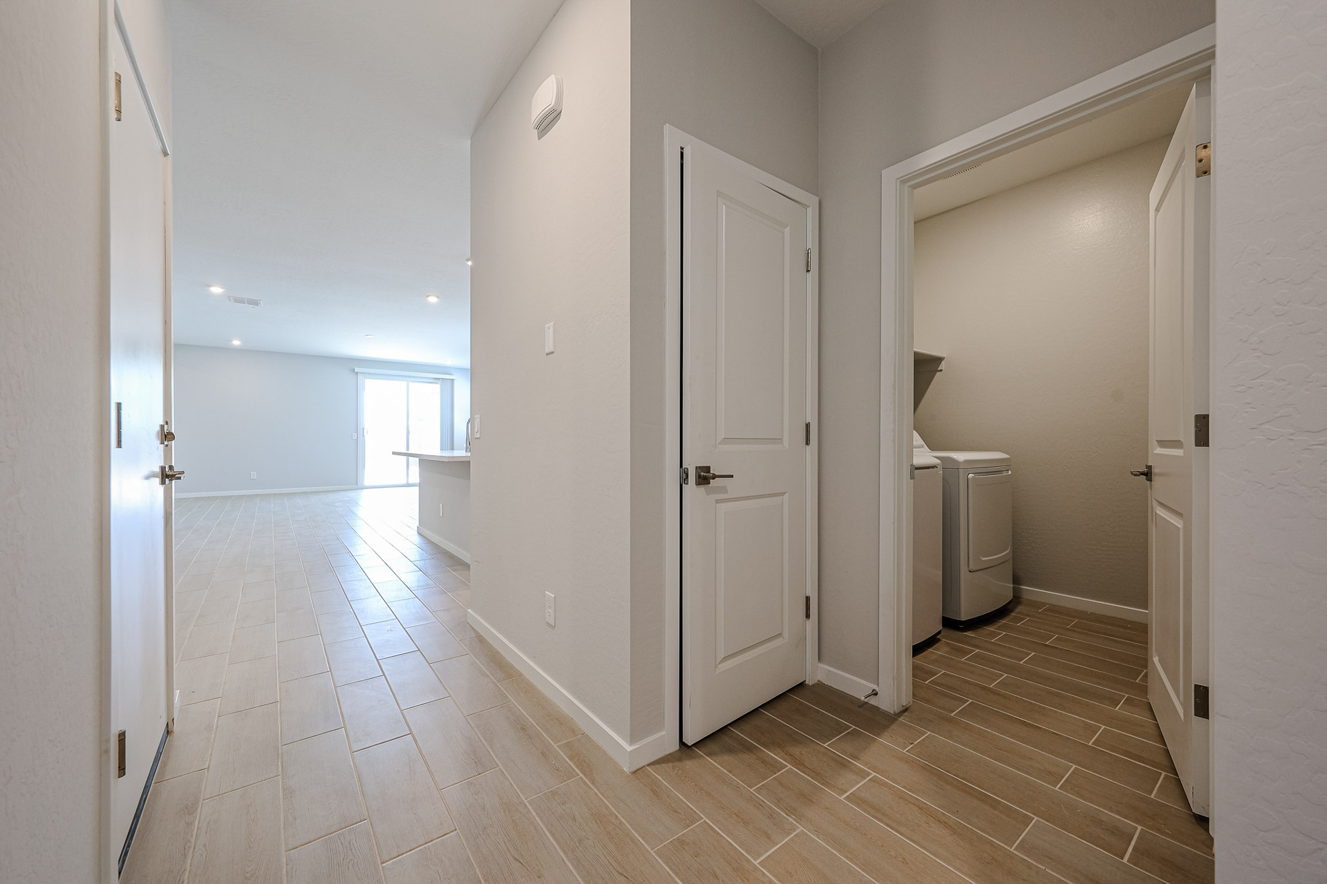A hallway with white doors.