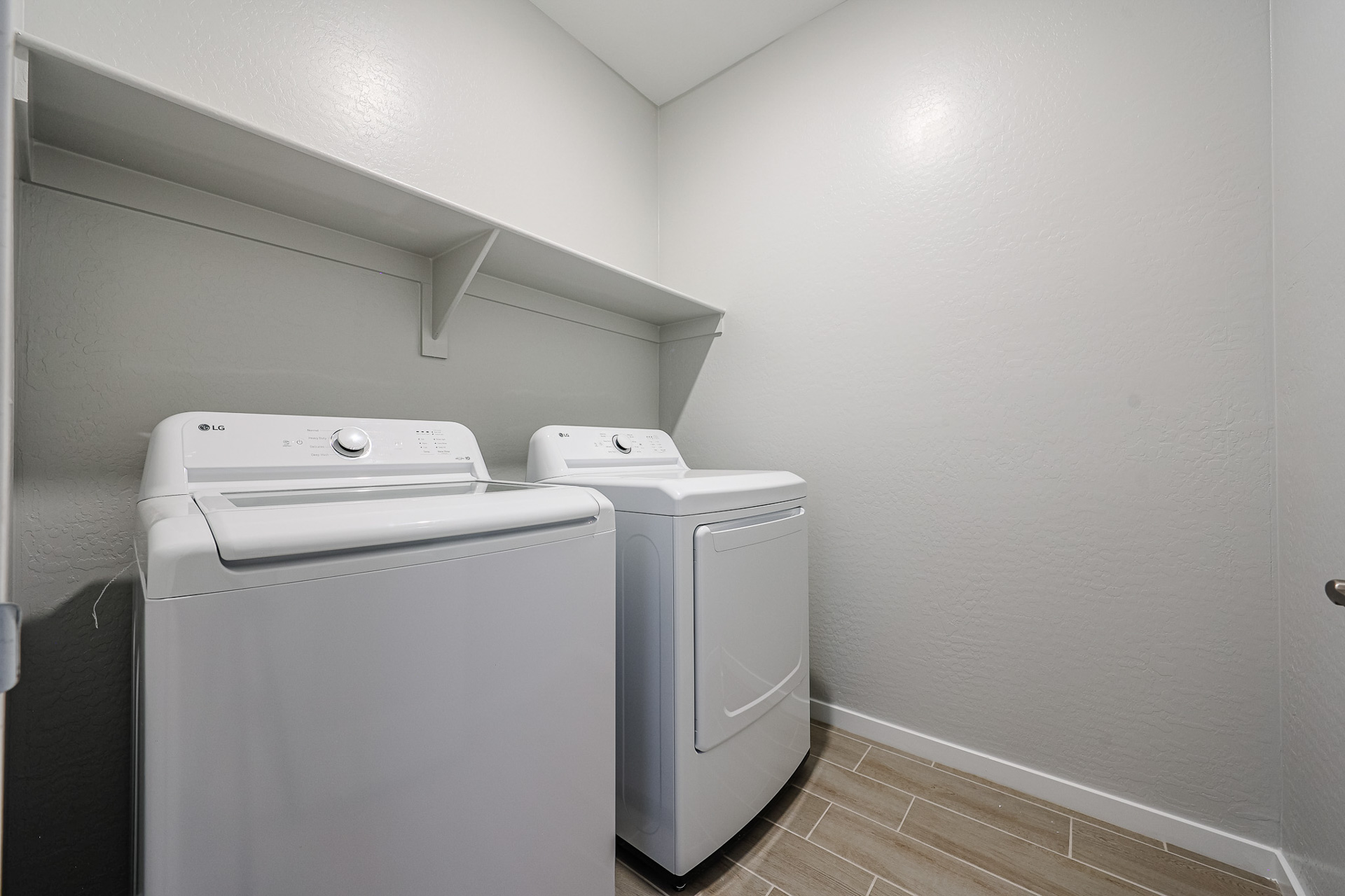 A washing machine and dryer in a room.