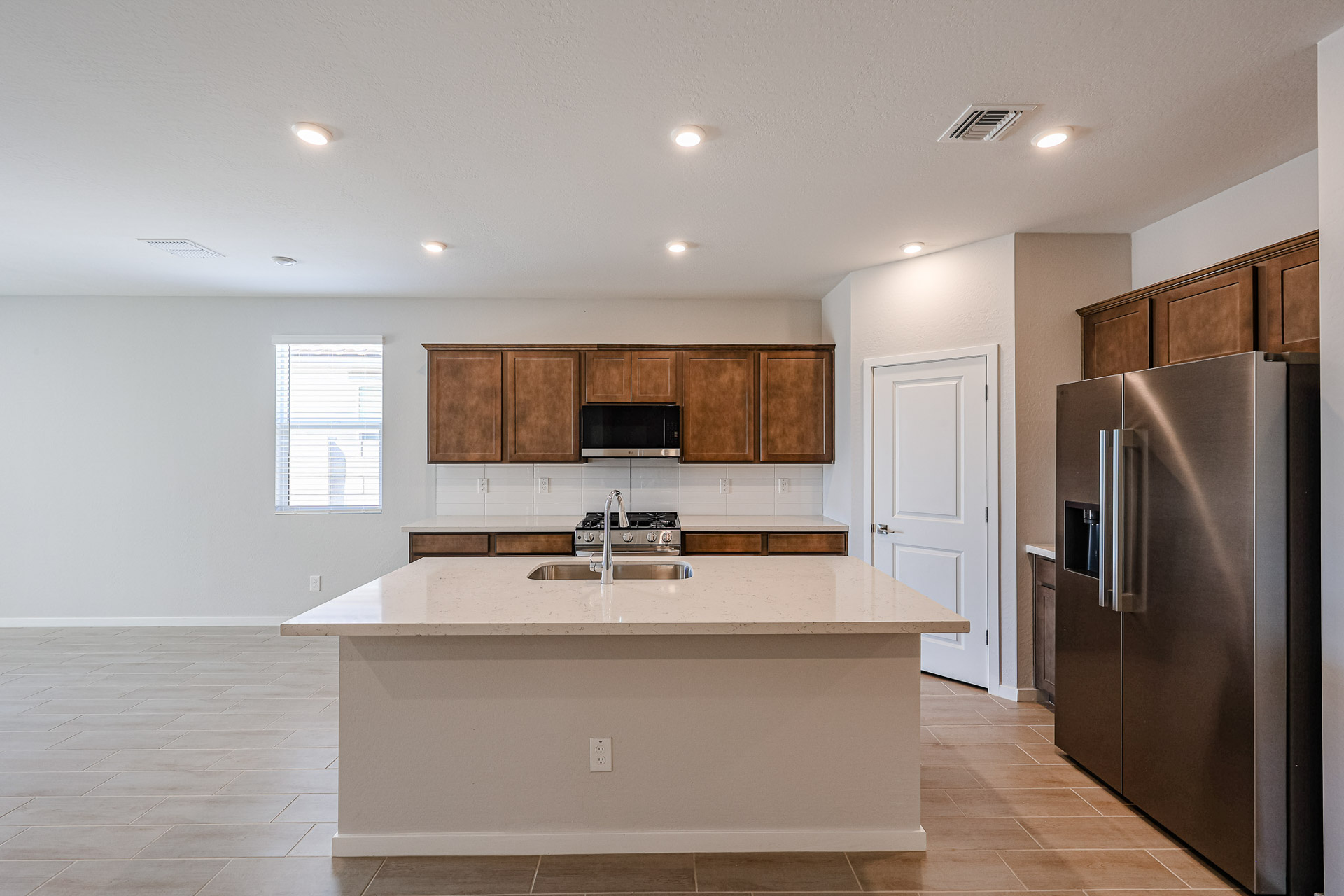 A kitchen with a fridge and a sink.
