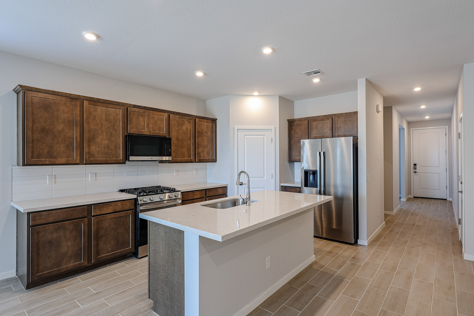 A kitchen with wooden cabinets.