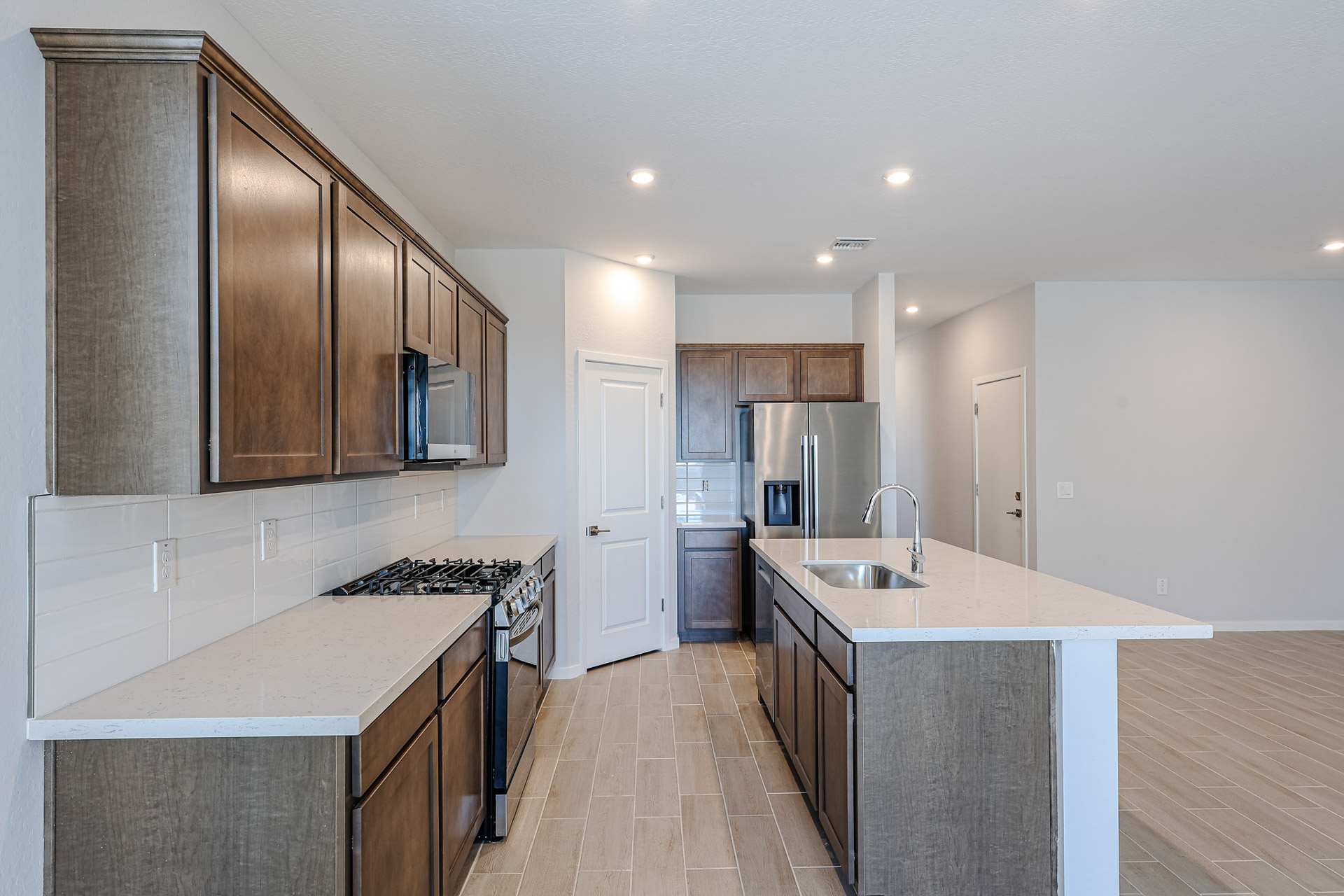 A kitchen with wooden cabinets.