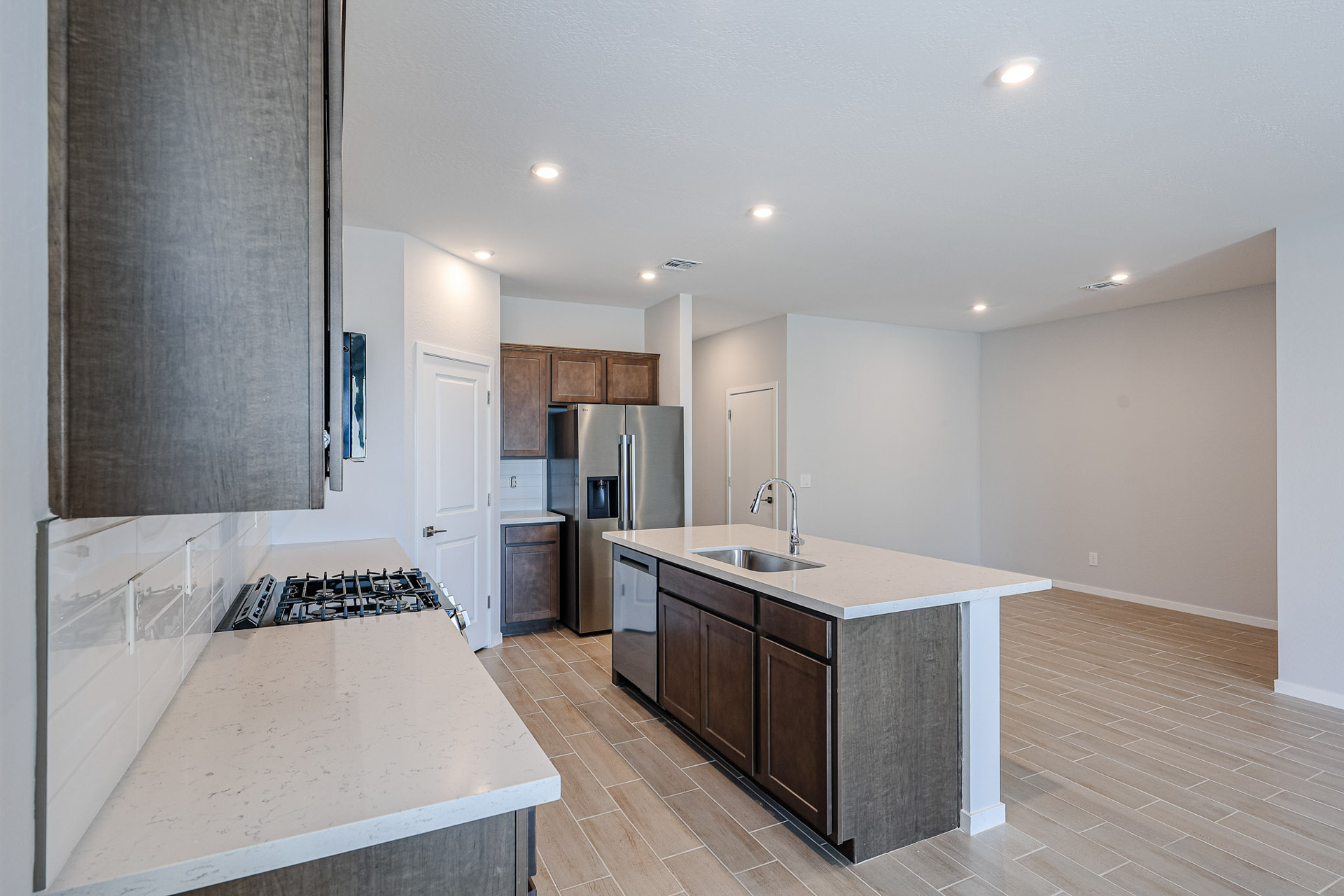 A kitchen with a wood floor.
