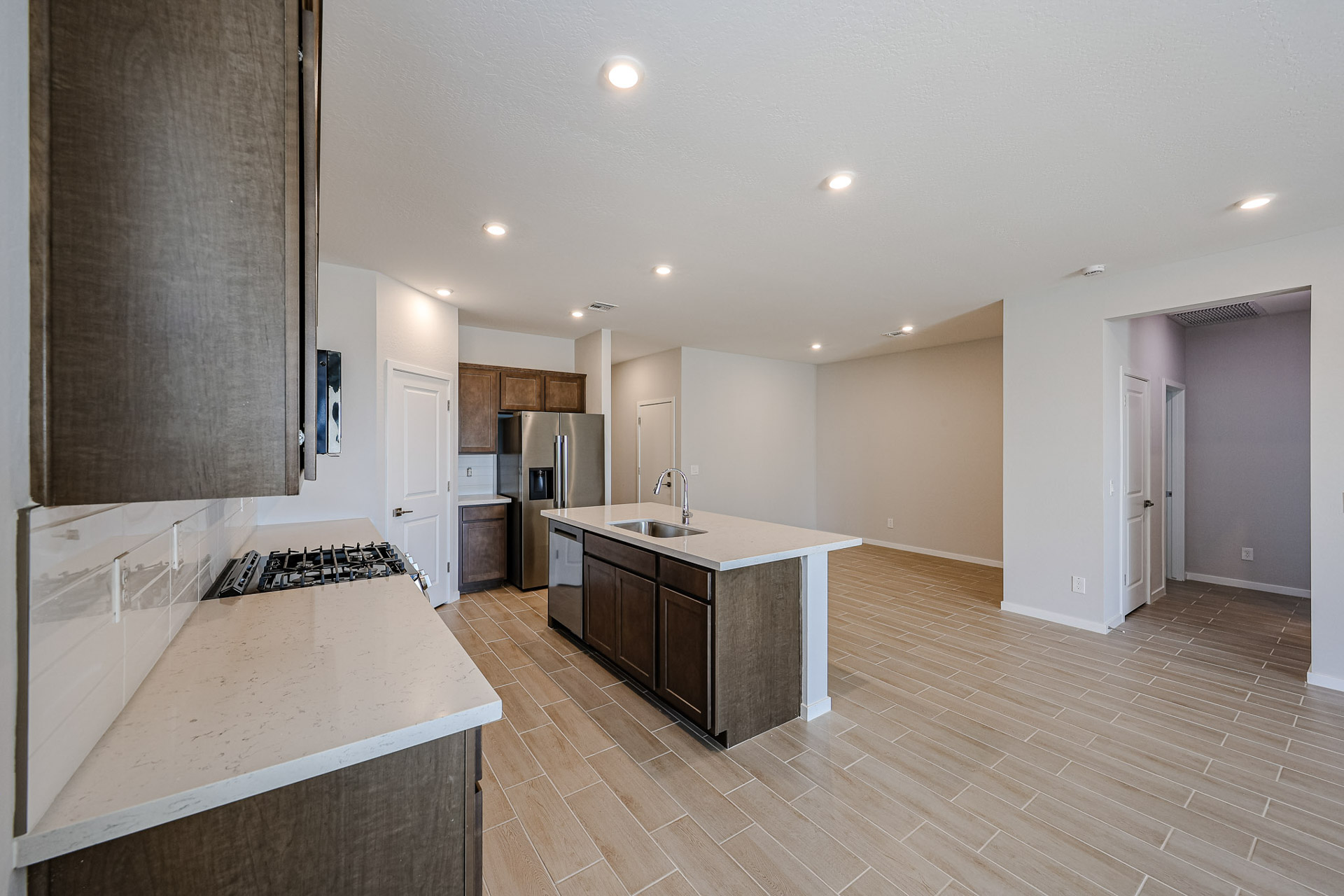 A large kitchen with a wood floor.