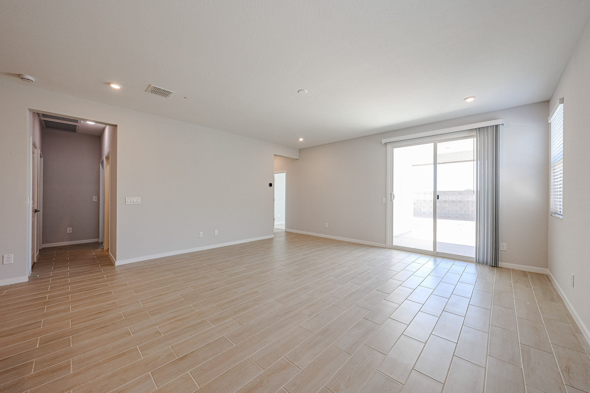 A room with a wood floor and white walls.