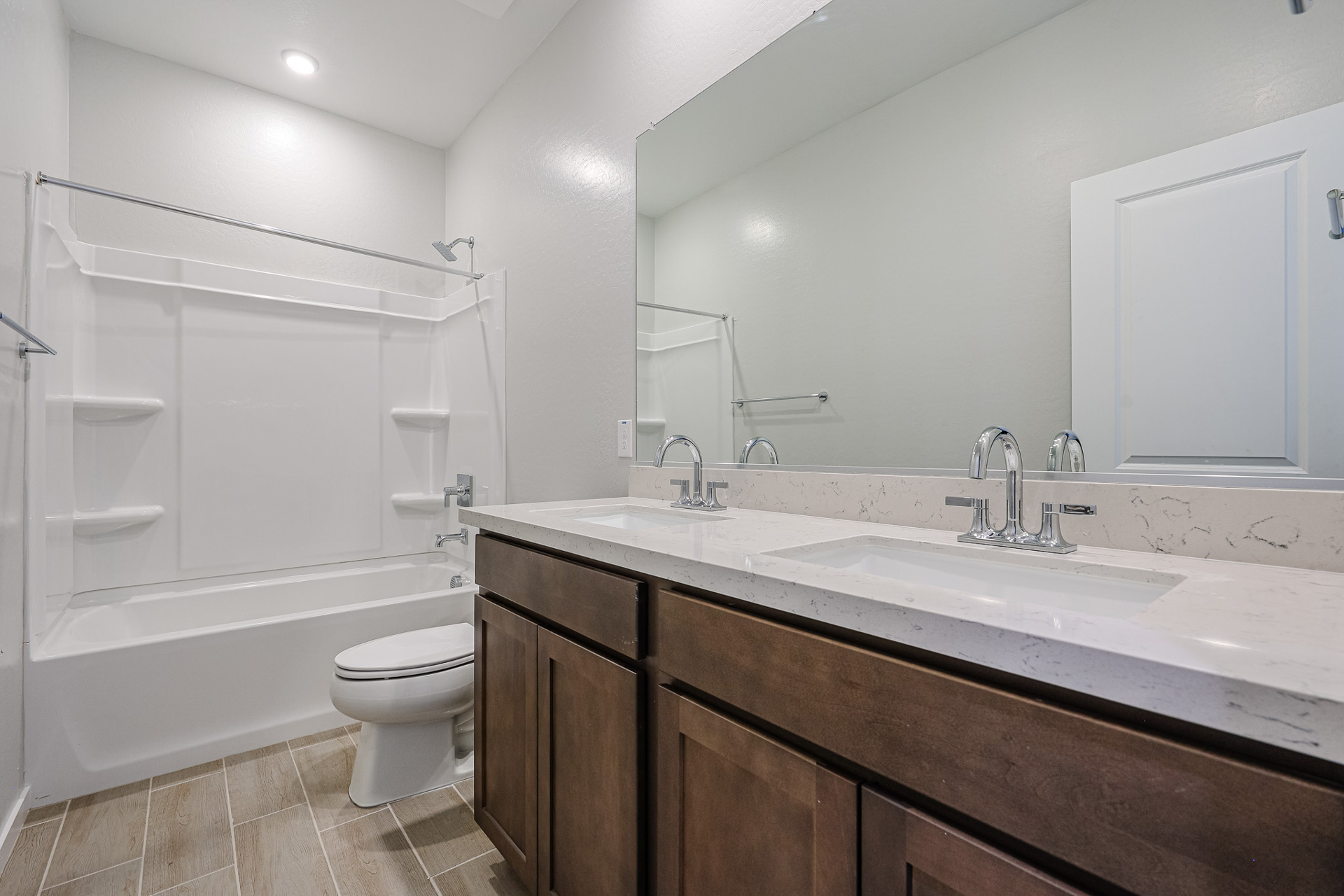 A bathroom with a tub sink and toilet.