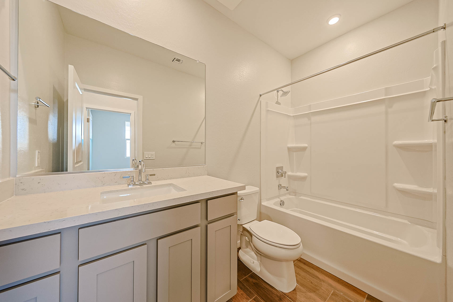 A bathroom with a tub sink and toilet.