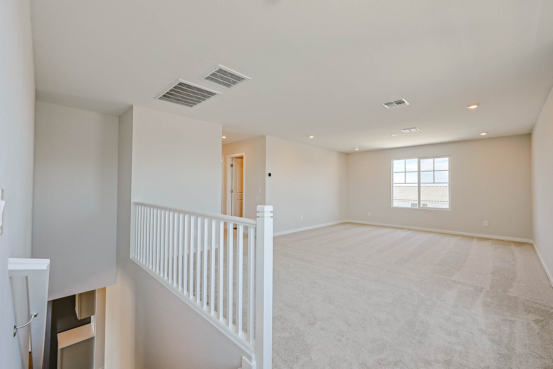 A room with a white railing and a white railing.