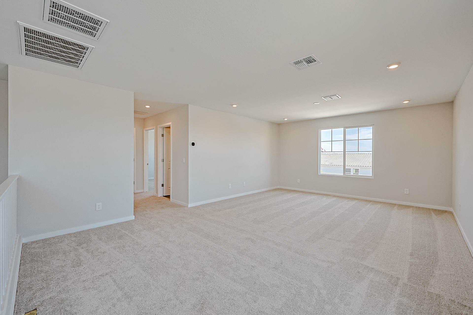 A room with a carpet and a window.