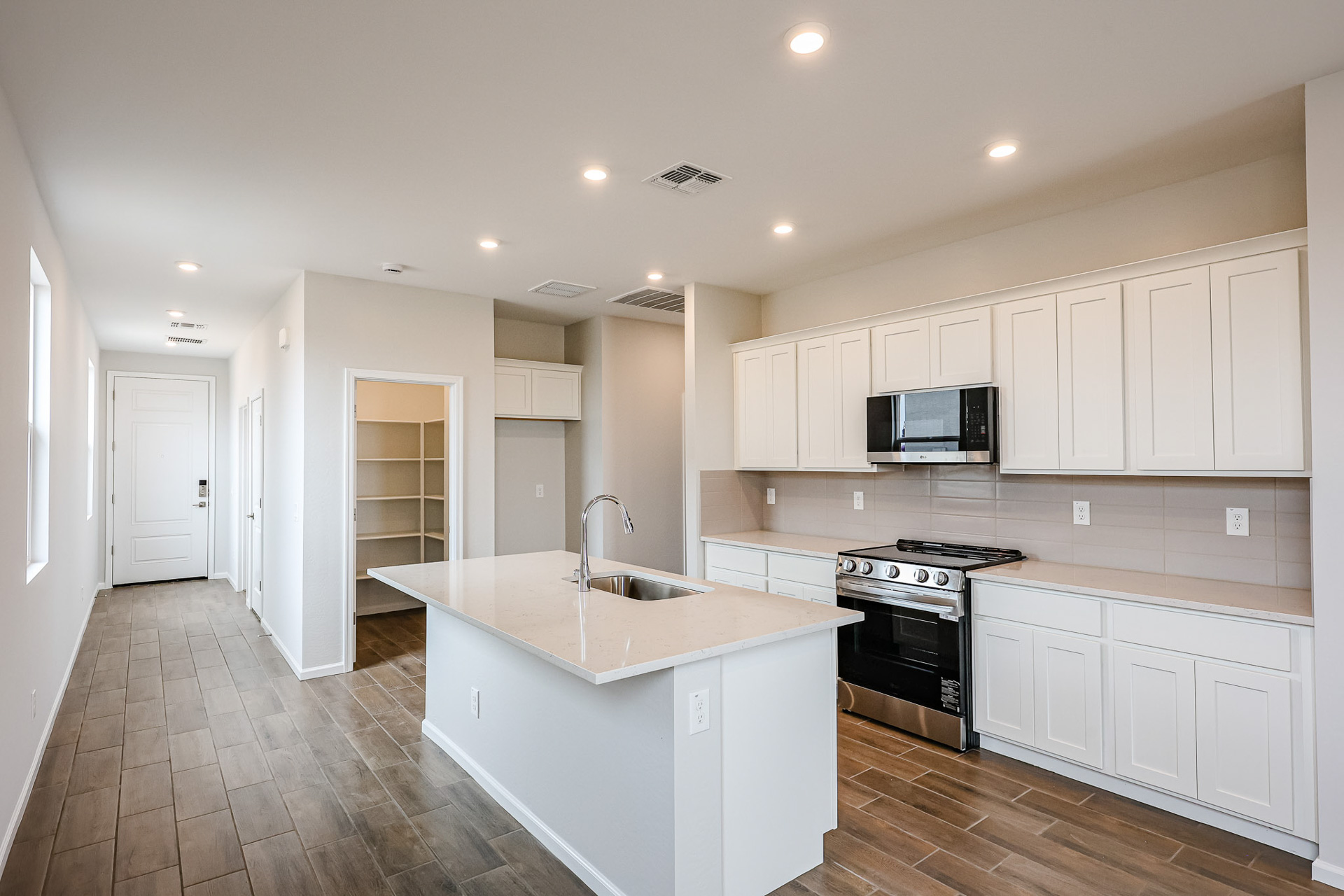 A kitchen with white cabinets.