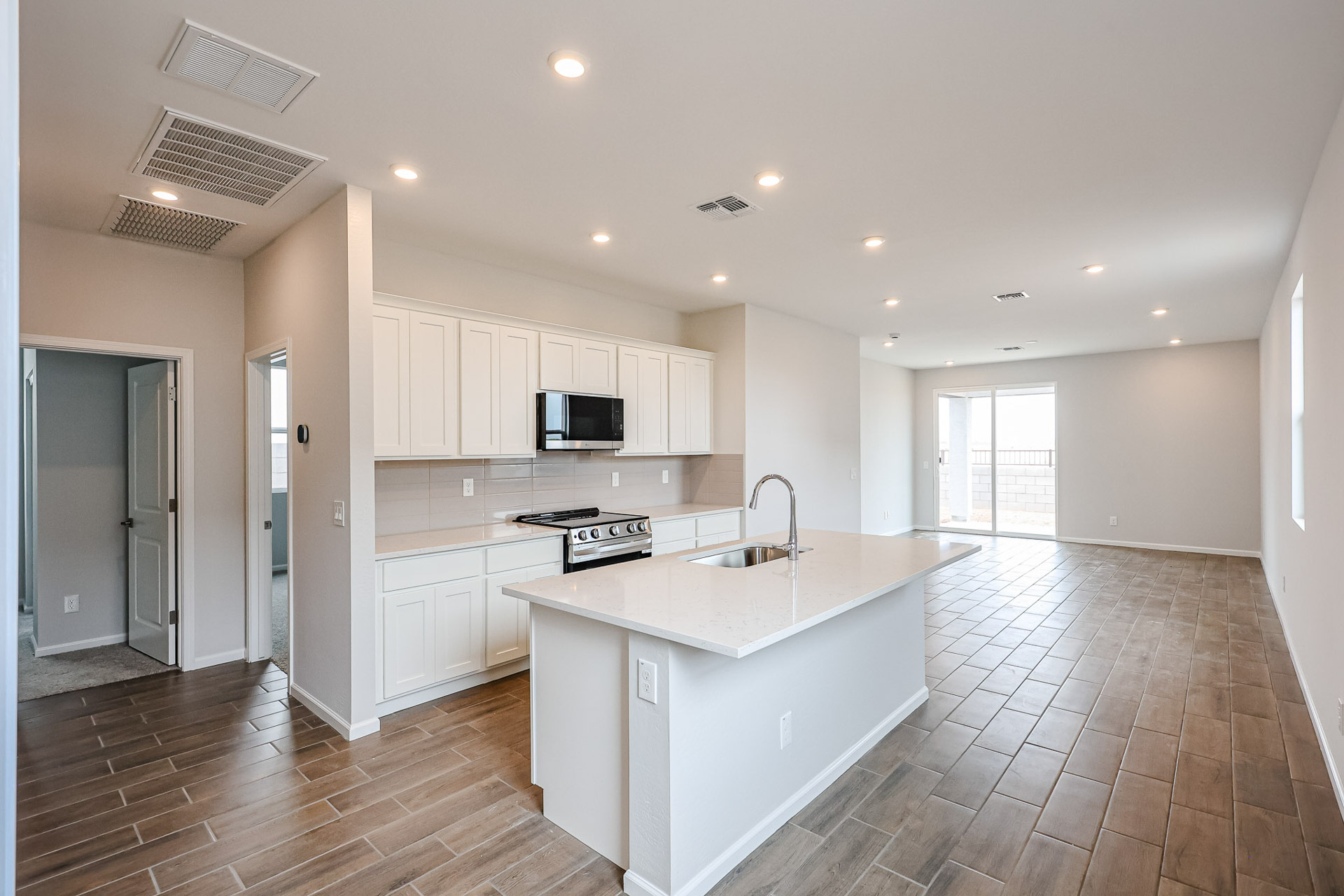 A kitchen with white cabinets.