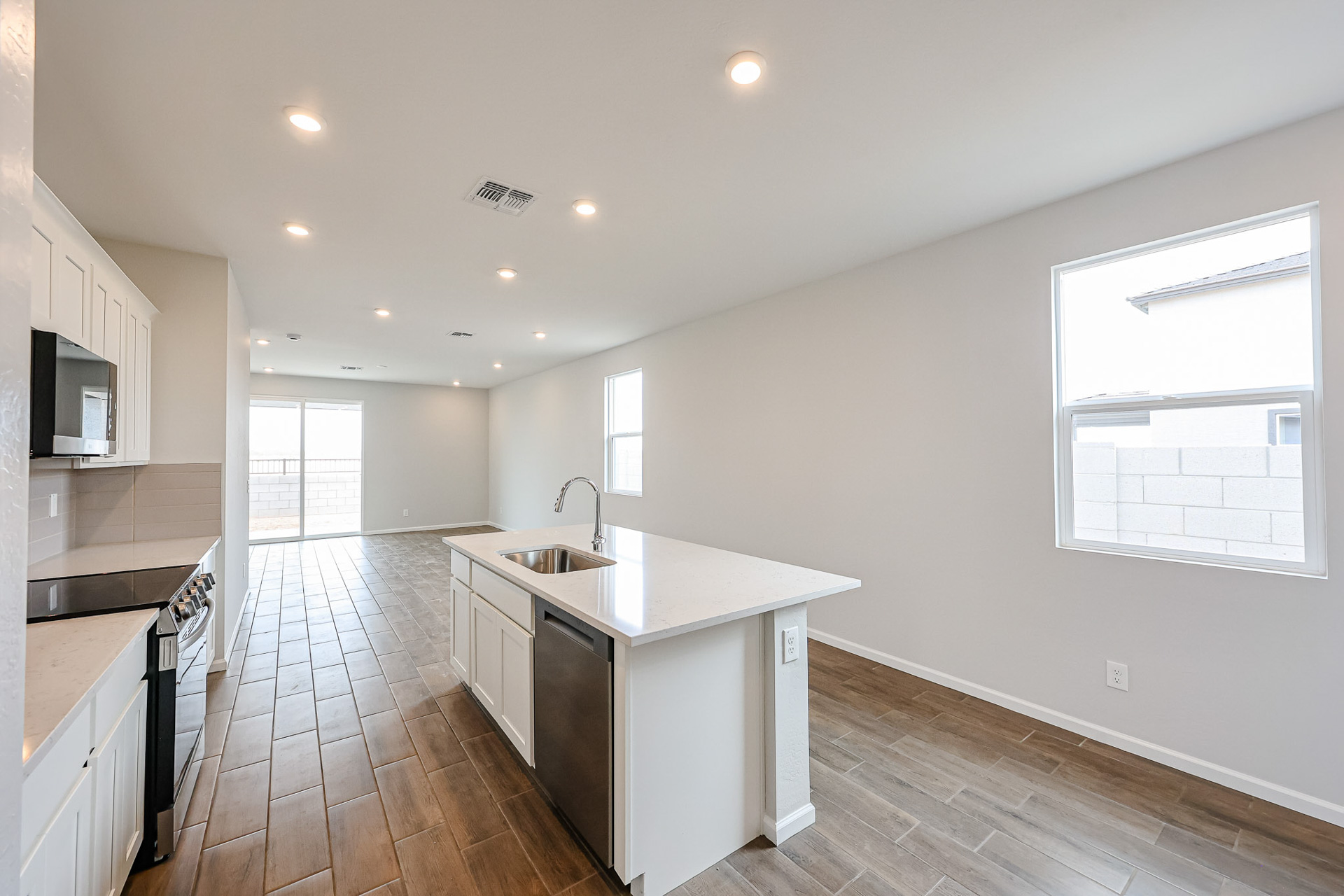 A kitchen with a wood floor.