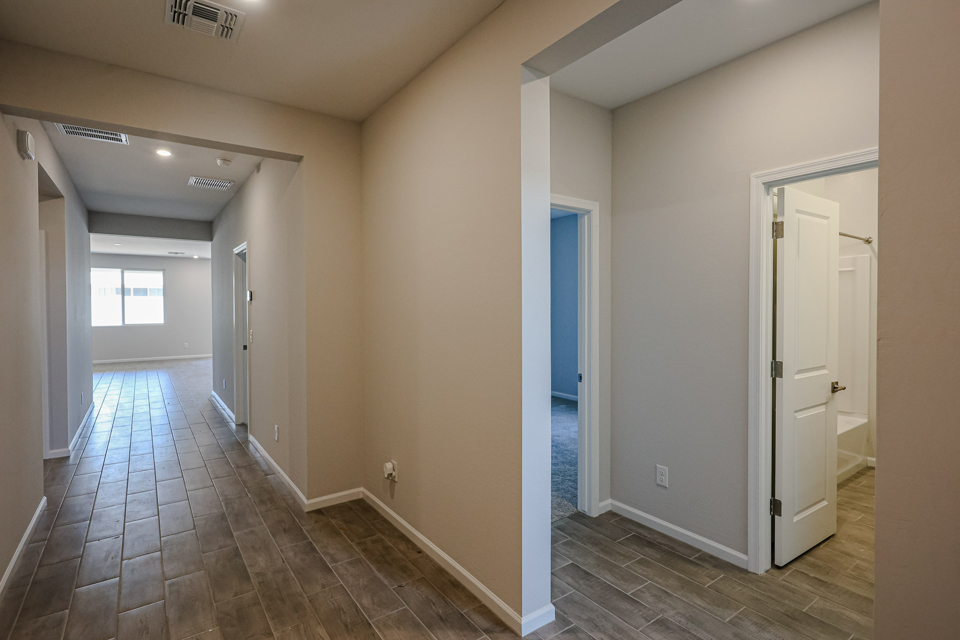 A hallway with white walls.