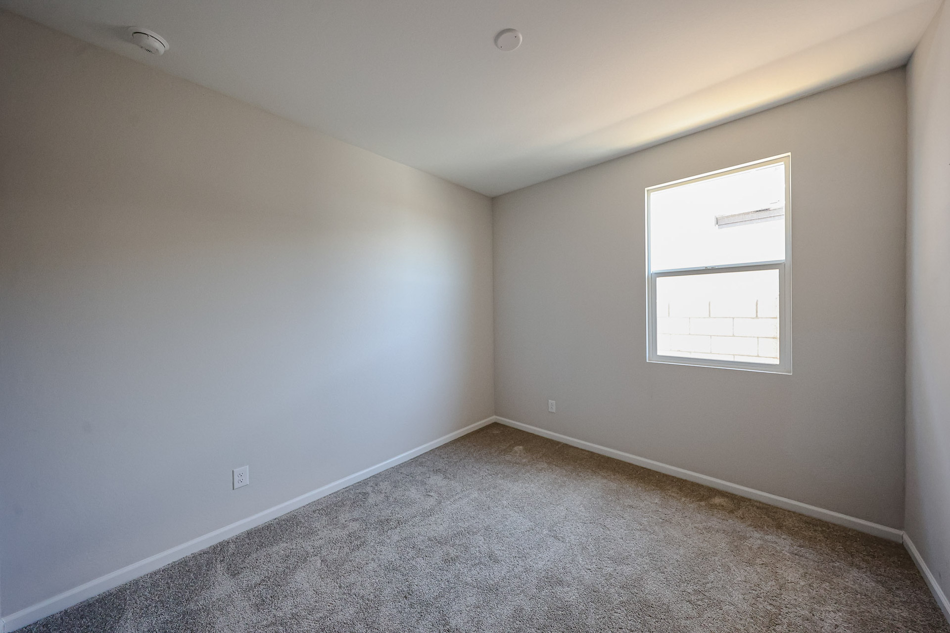 A room with a white wall and a white door.