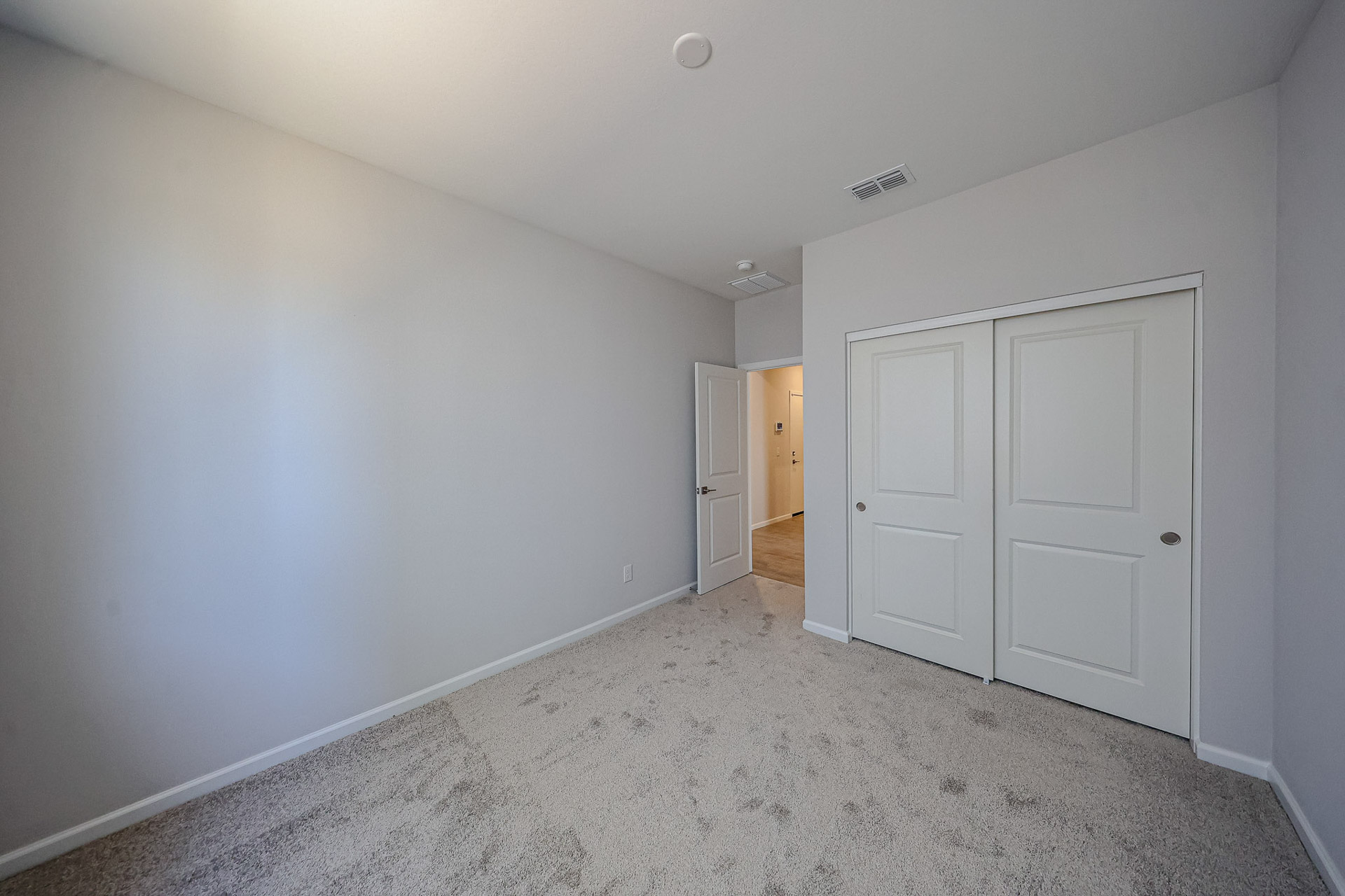 A hallway with white doors.