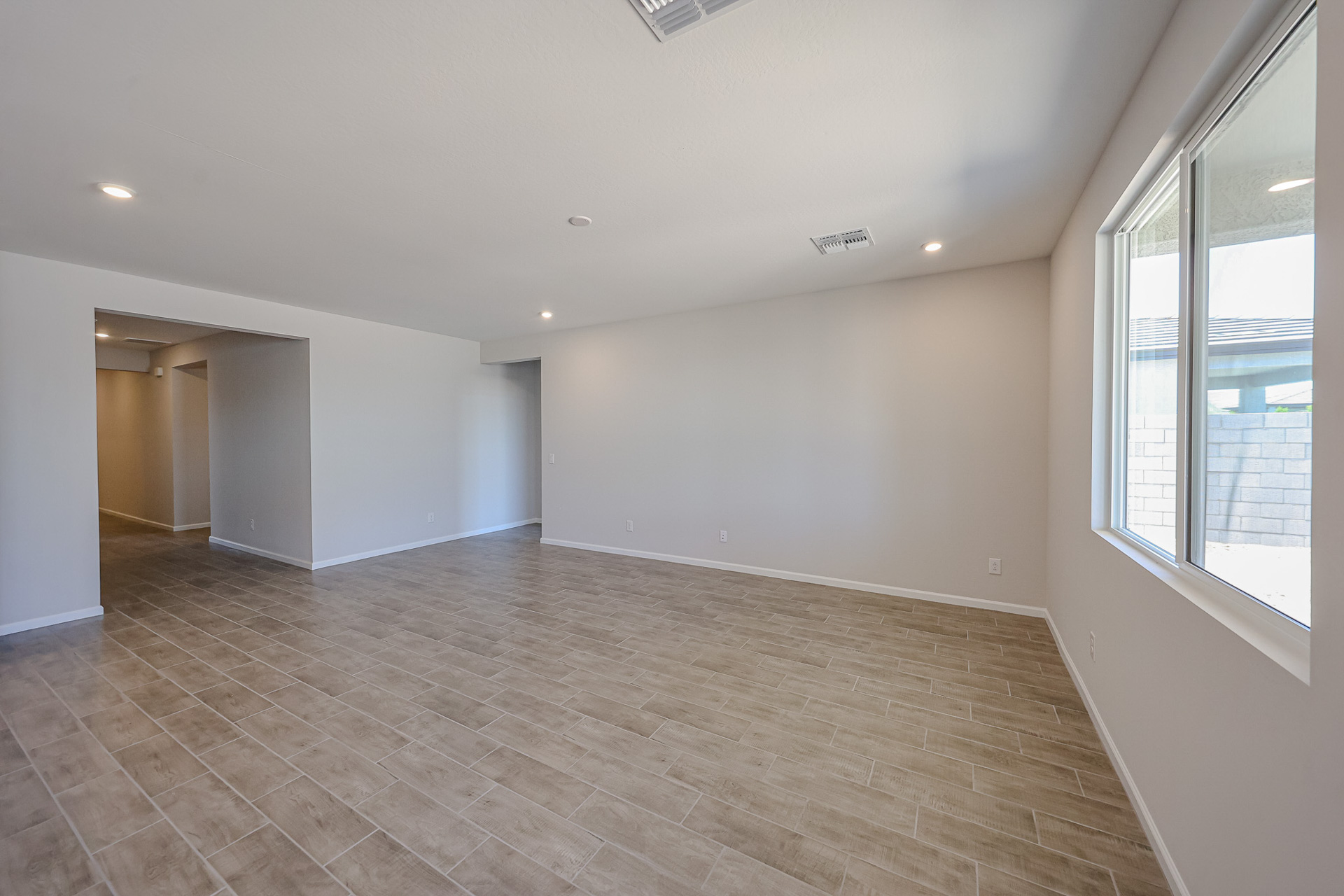 A room with a wood floor and windows.