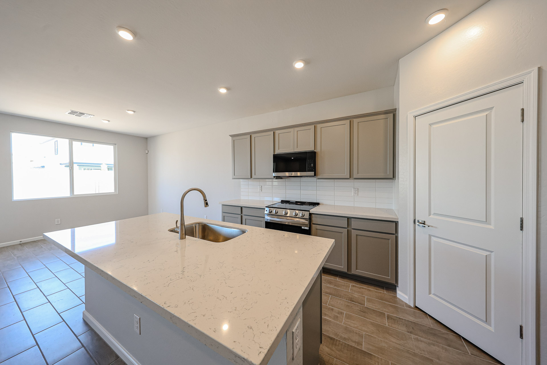 A kitchen with white cabinets.