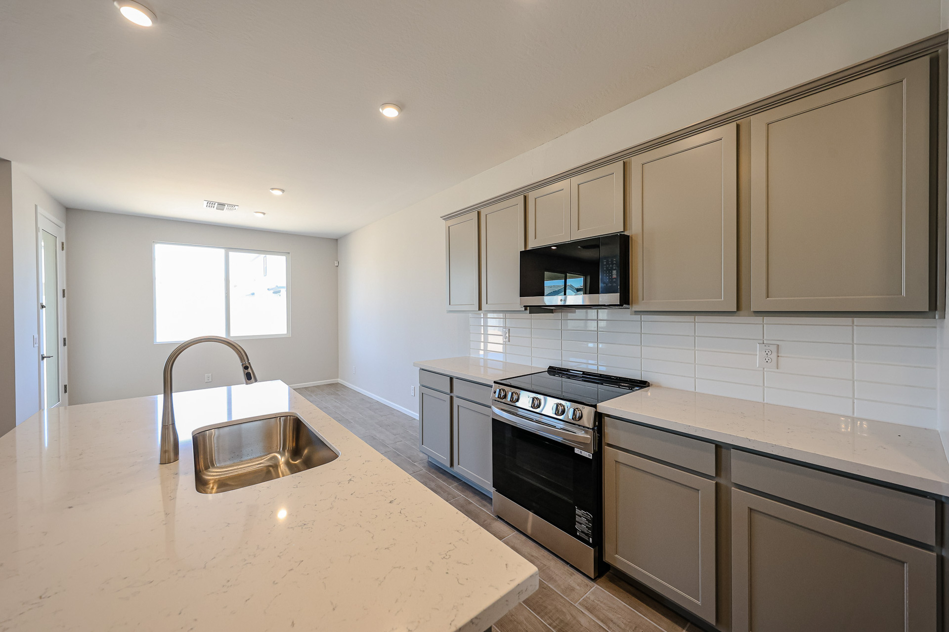 A kitchen with white cabinets.