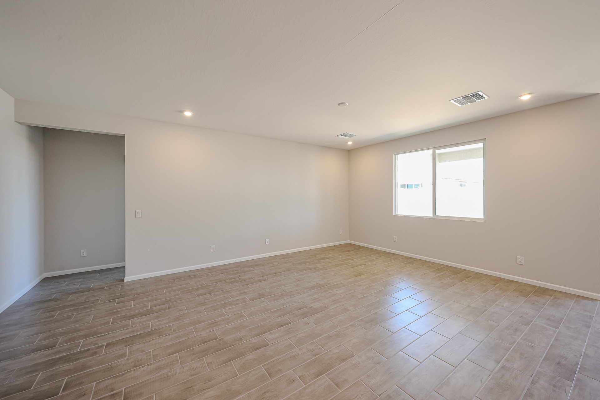 A room with a wood floor and white walls.