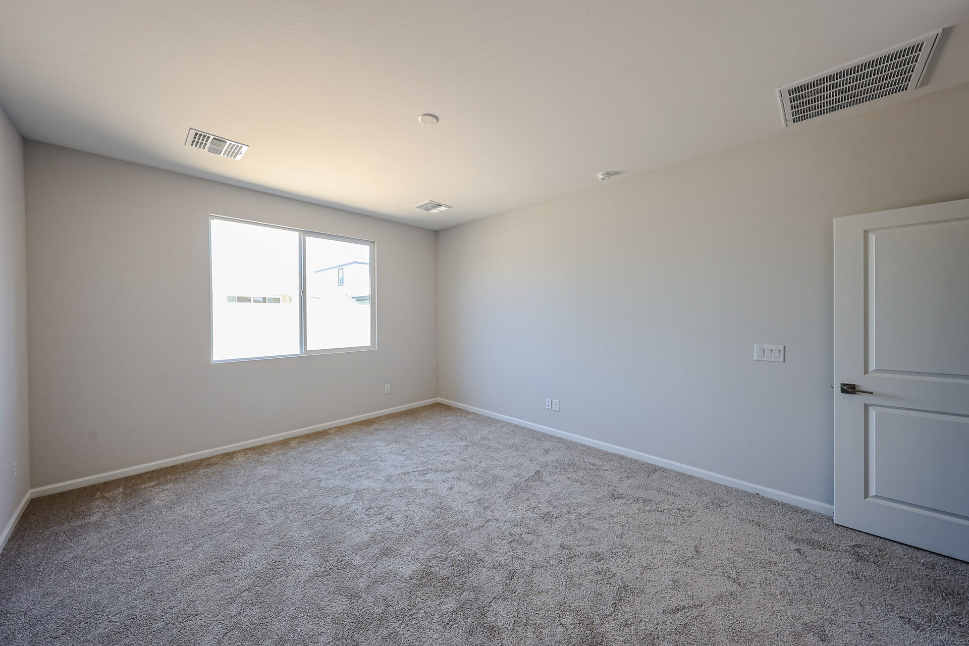 A room with white walls and a window.