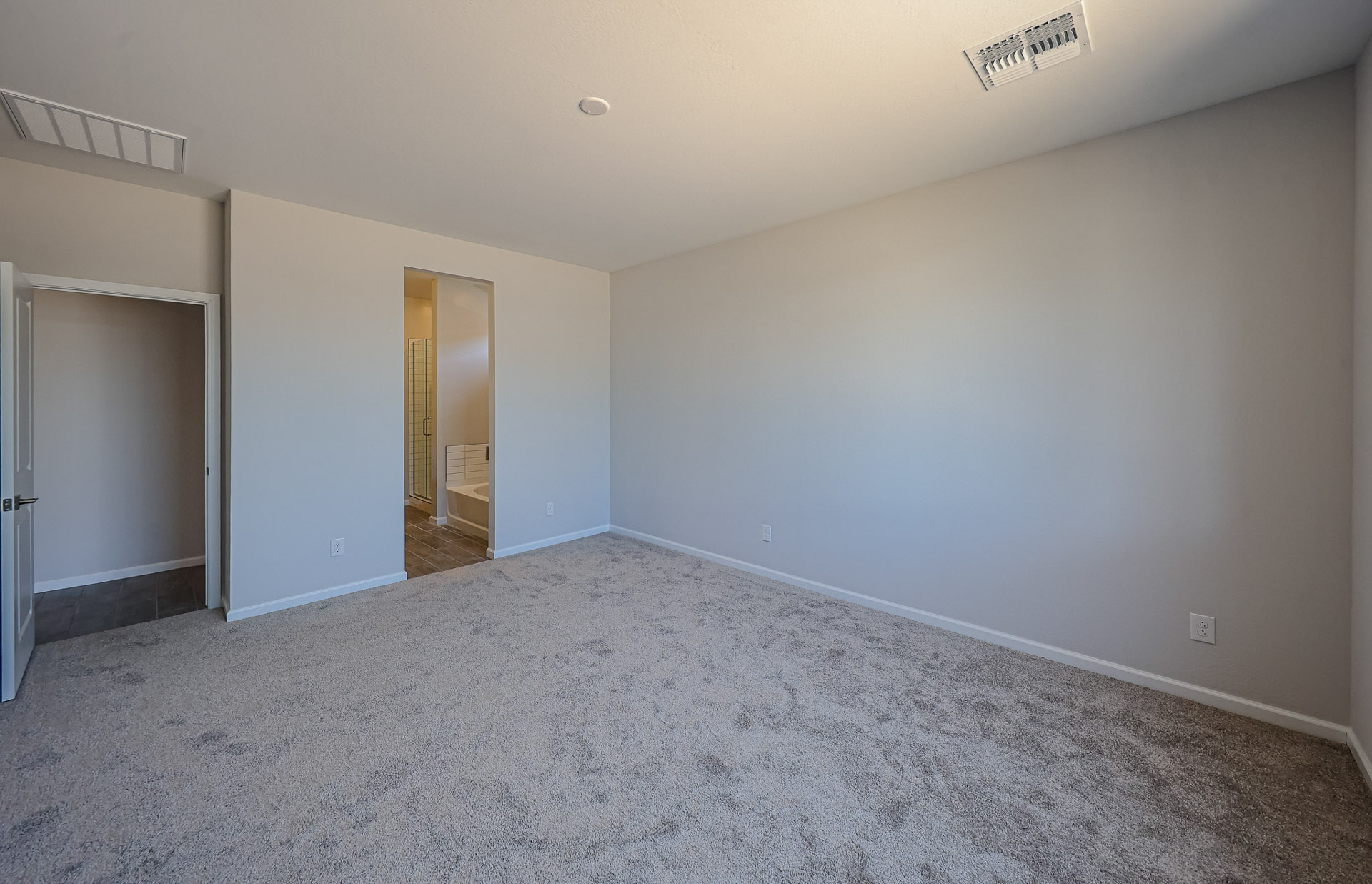 A room with carpet and a door.
