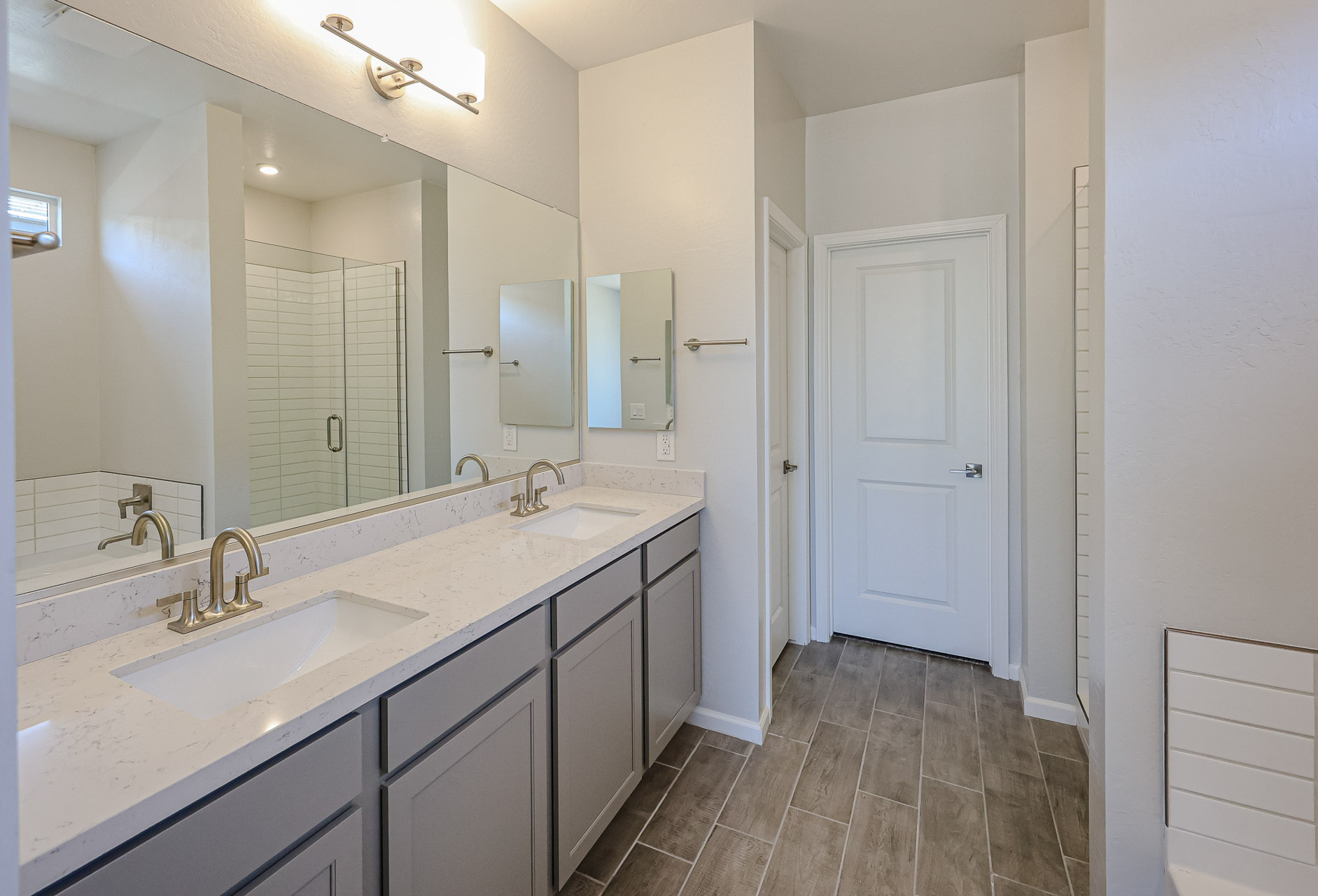 A bathroom with a large mirror.