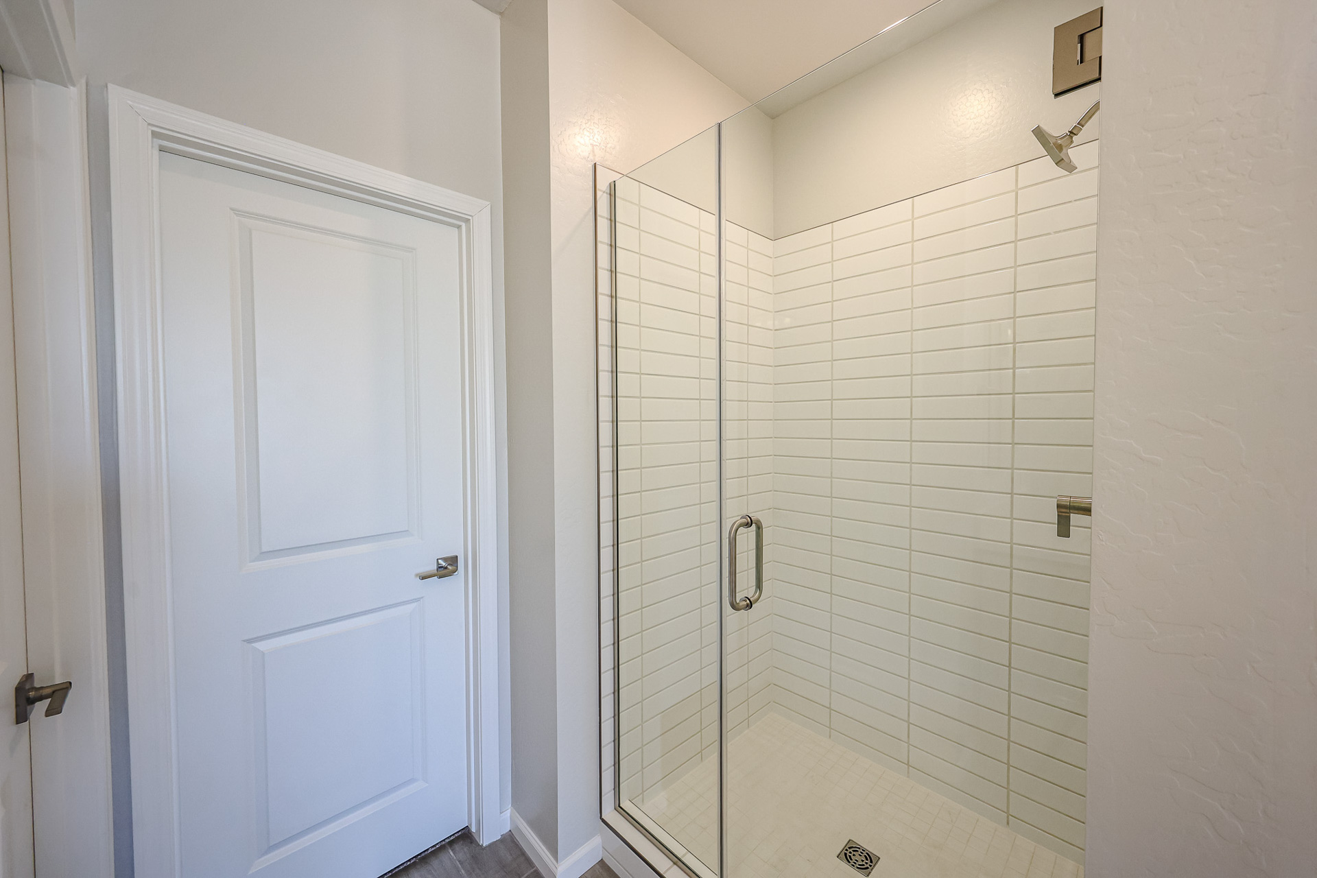 A shower with a glass door.