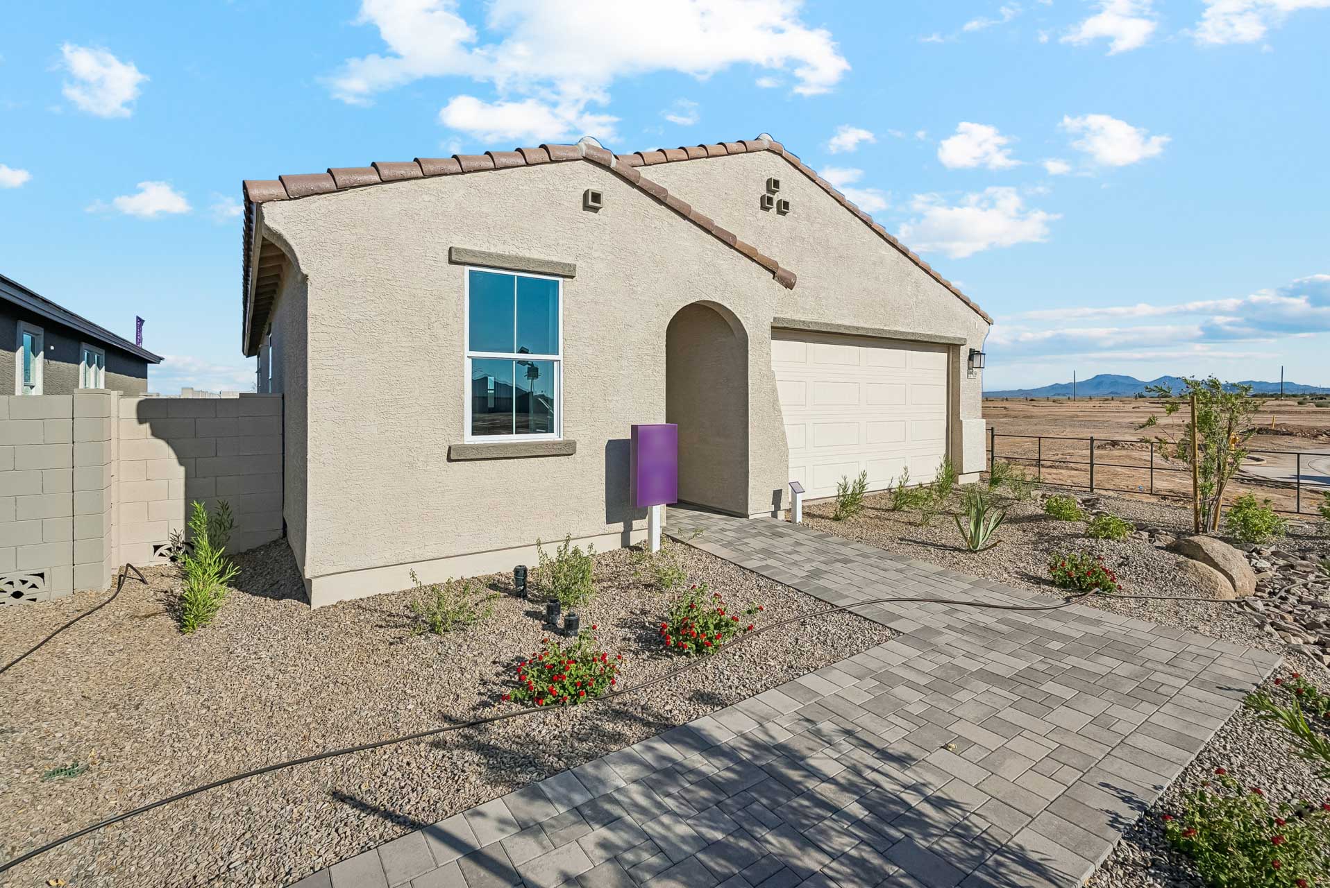 A house with a brick driveway.