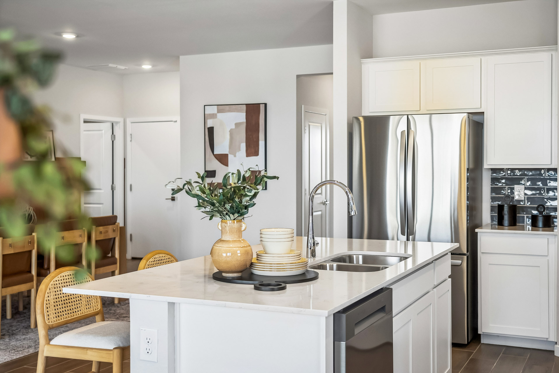 A kitchen with white cabinets.
