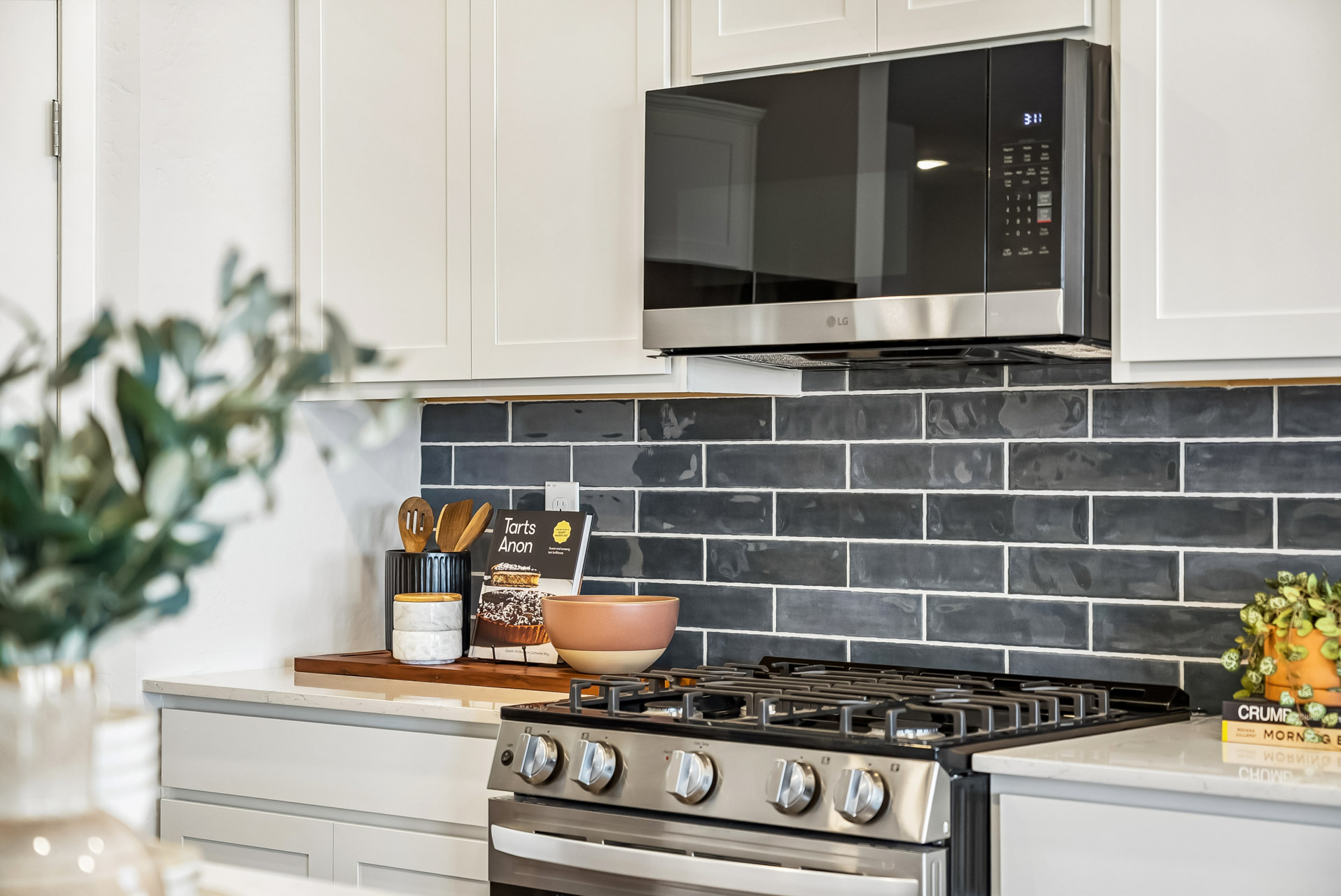 A kitchen with a stove and microwave.