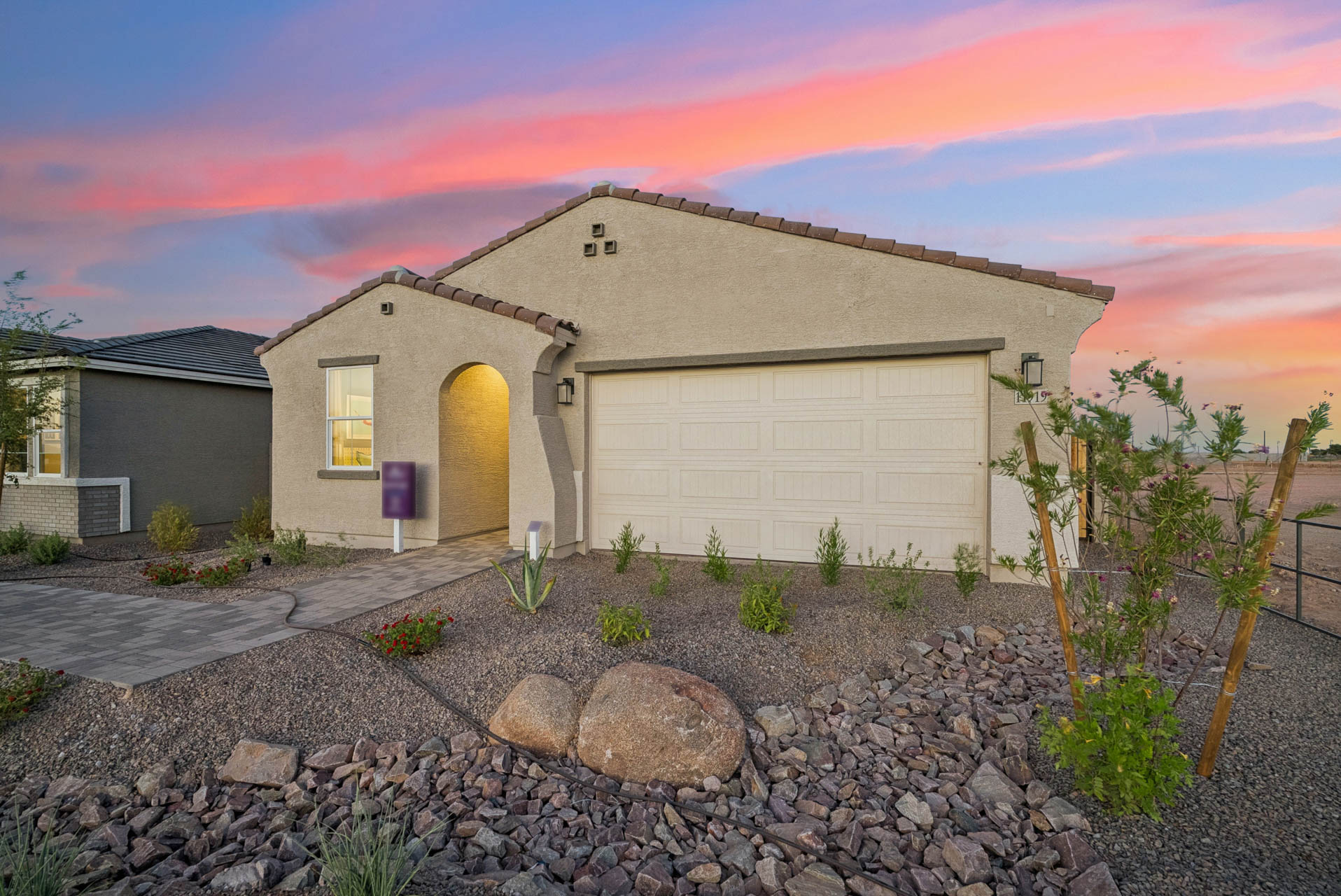 A house with a gravel driveway.