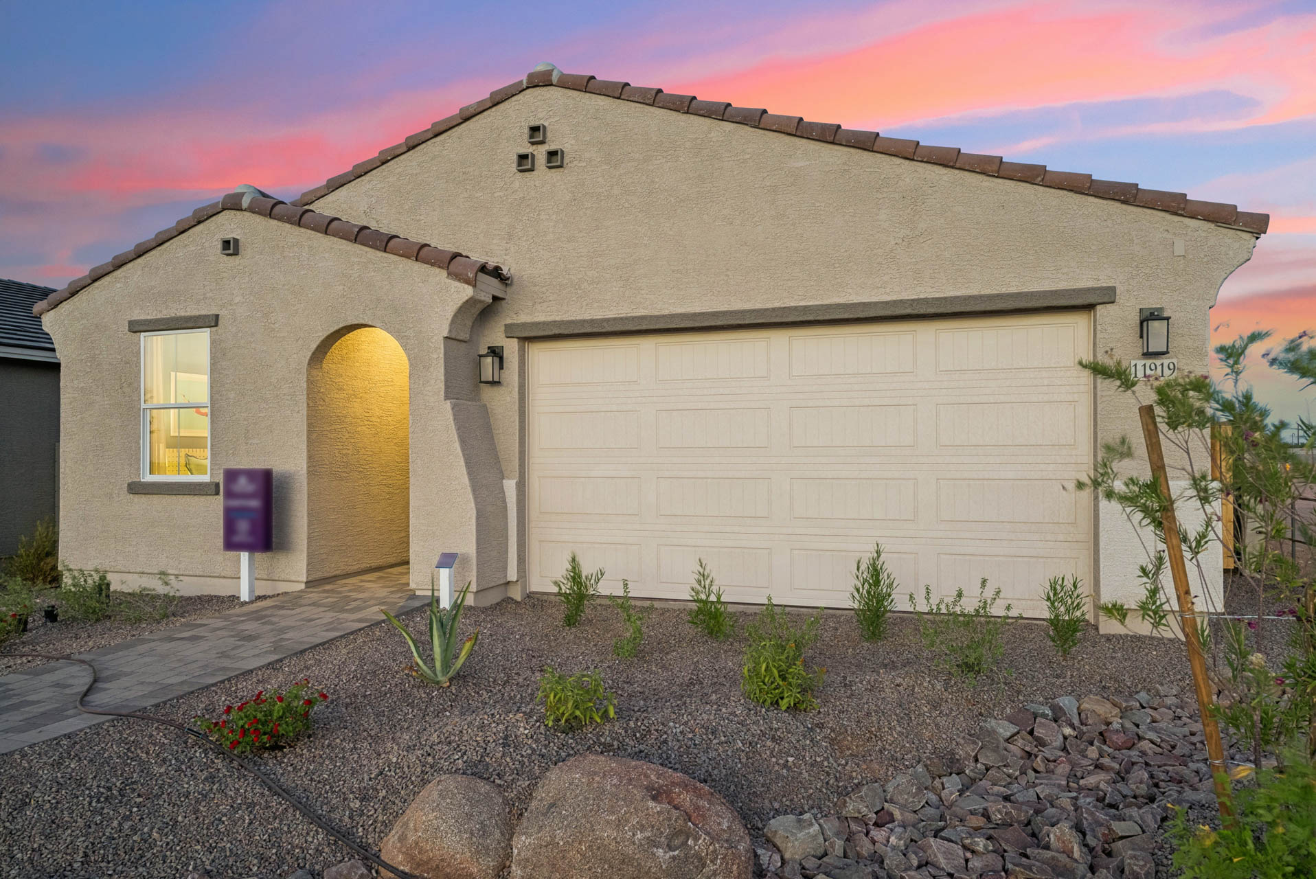 A house with a garage and a gravel driveway.