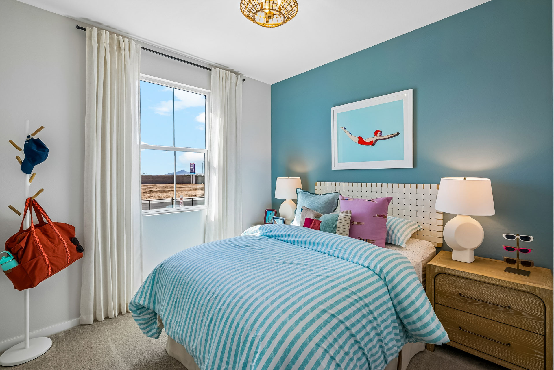 A bedroom with a bed and a window.