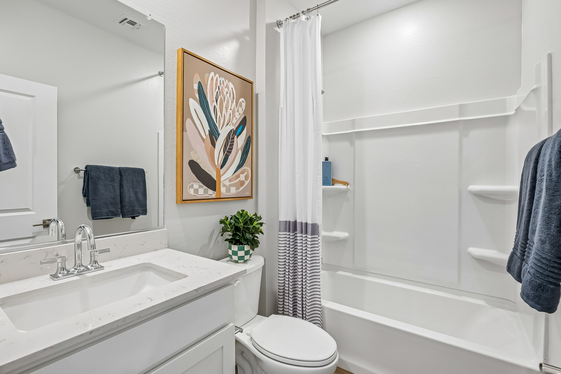 A bathroom with a white shower curtain.