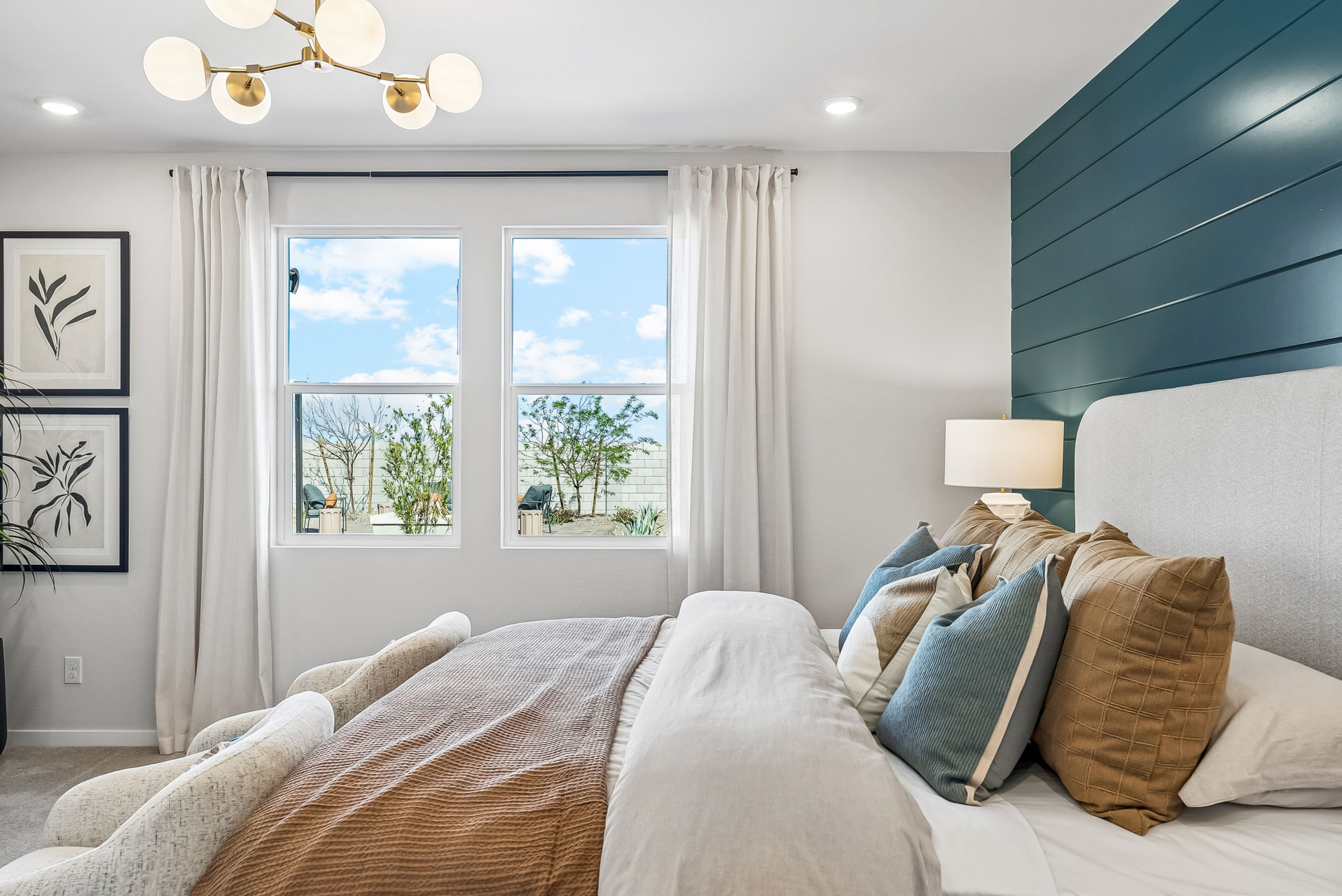 A bedroom with a large window.
