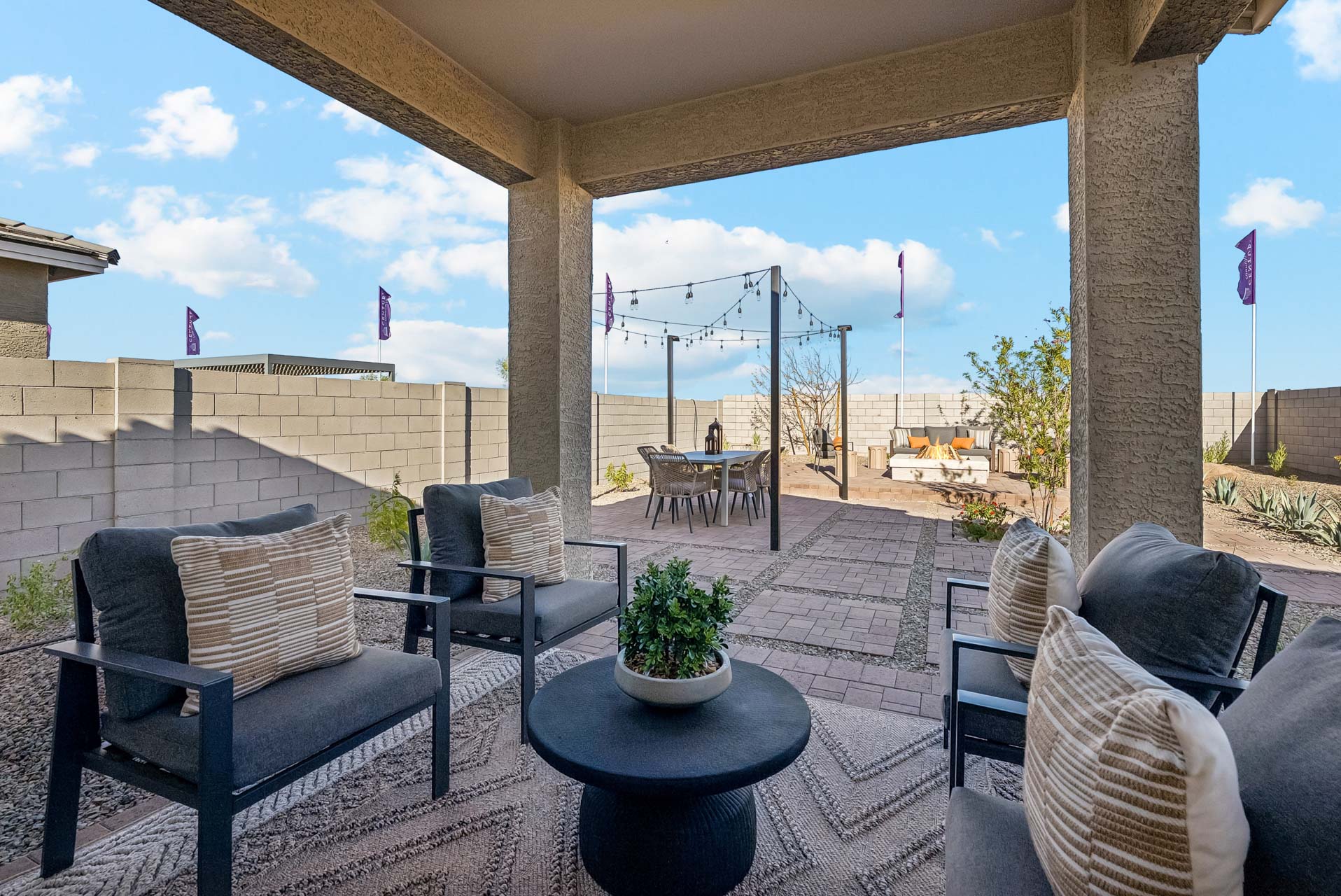 A patio with chairs and a table.