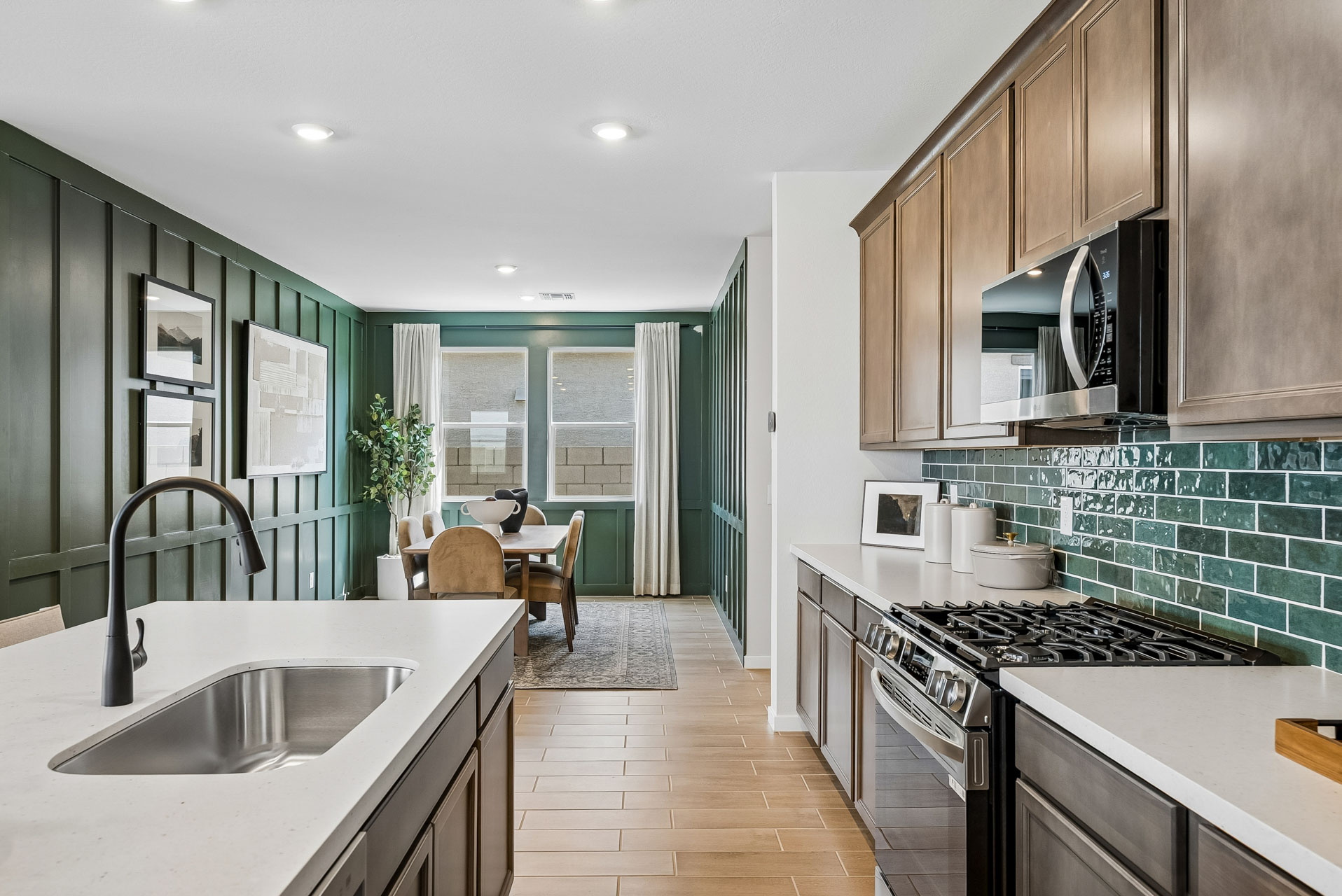 A kitchen with a table and chairs.