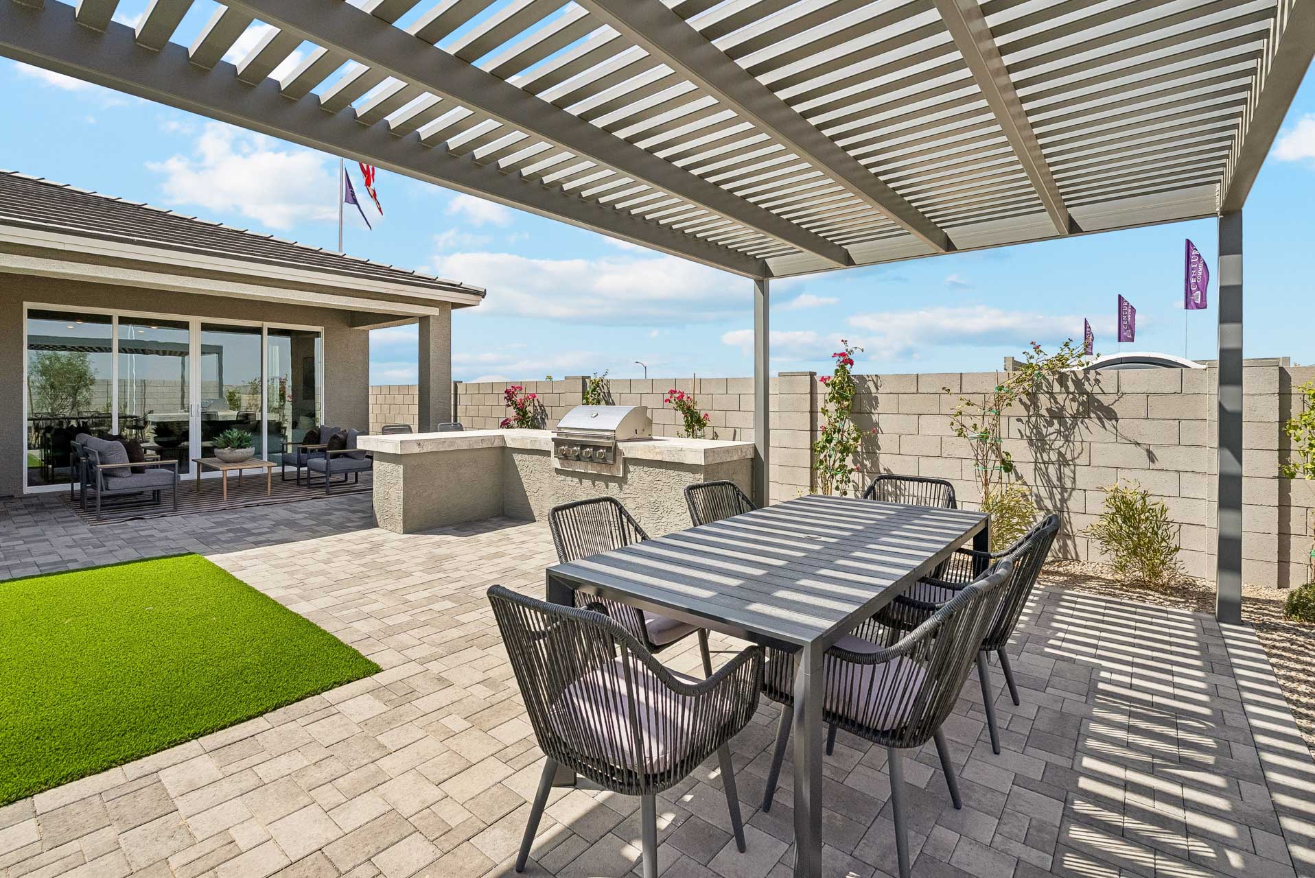 A patio with a table and chairs.