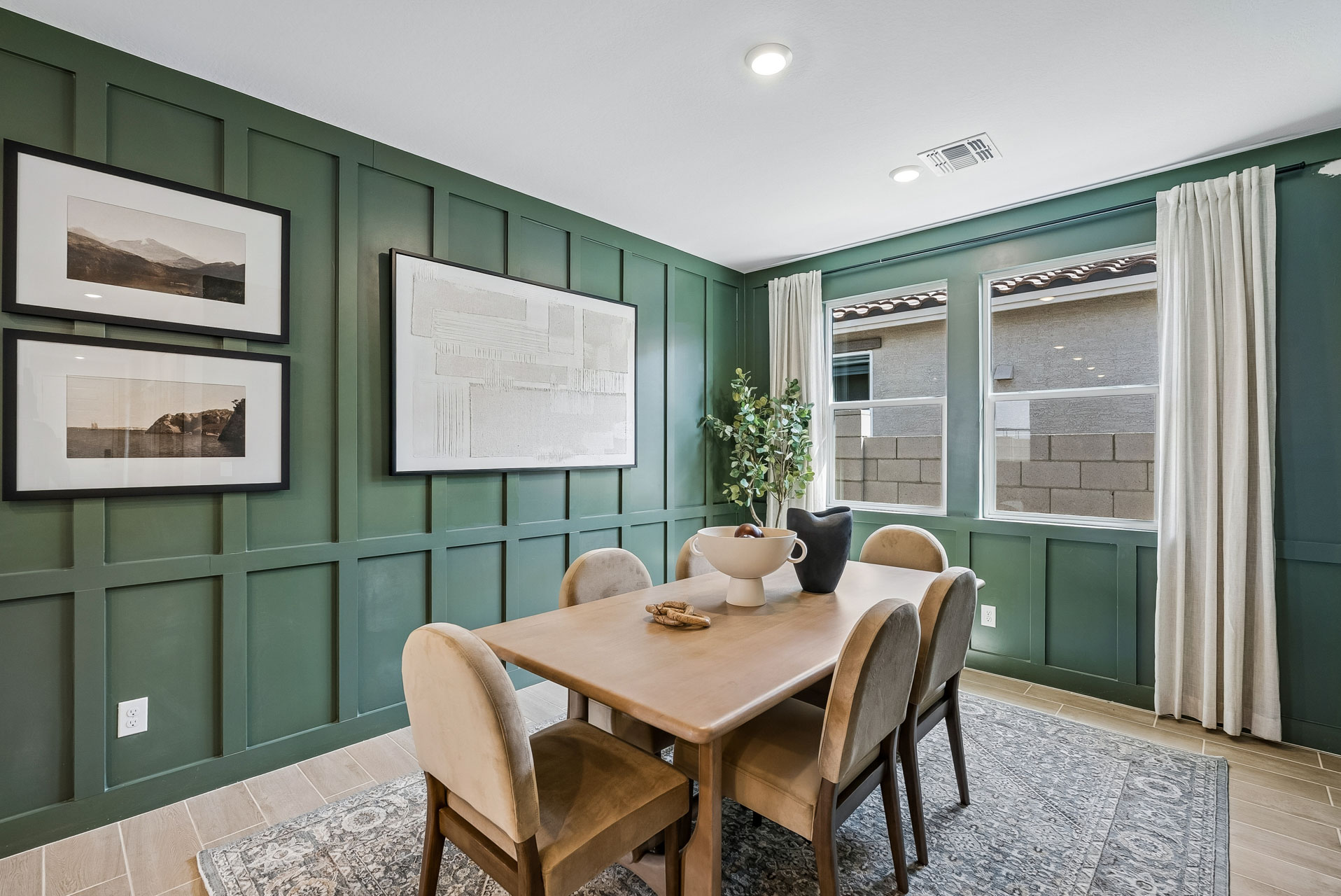 A dining room with a table and chairs.