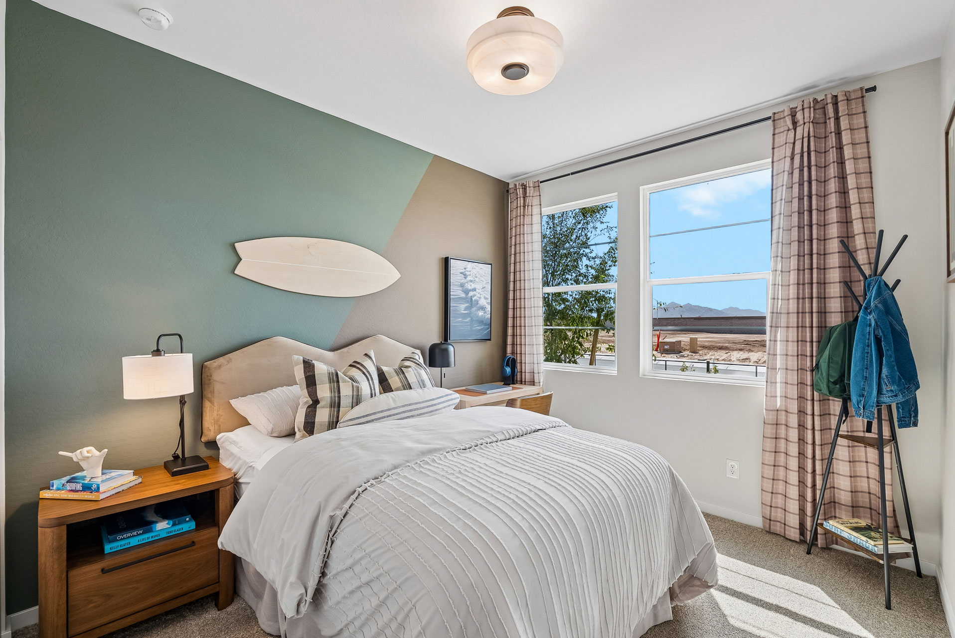 A bedroom with a large window.