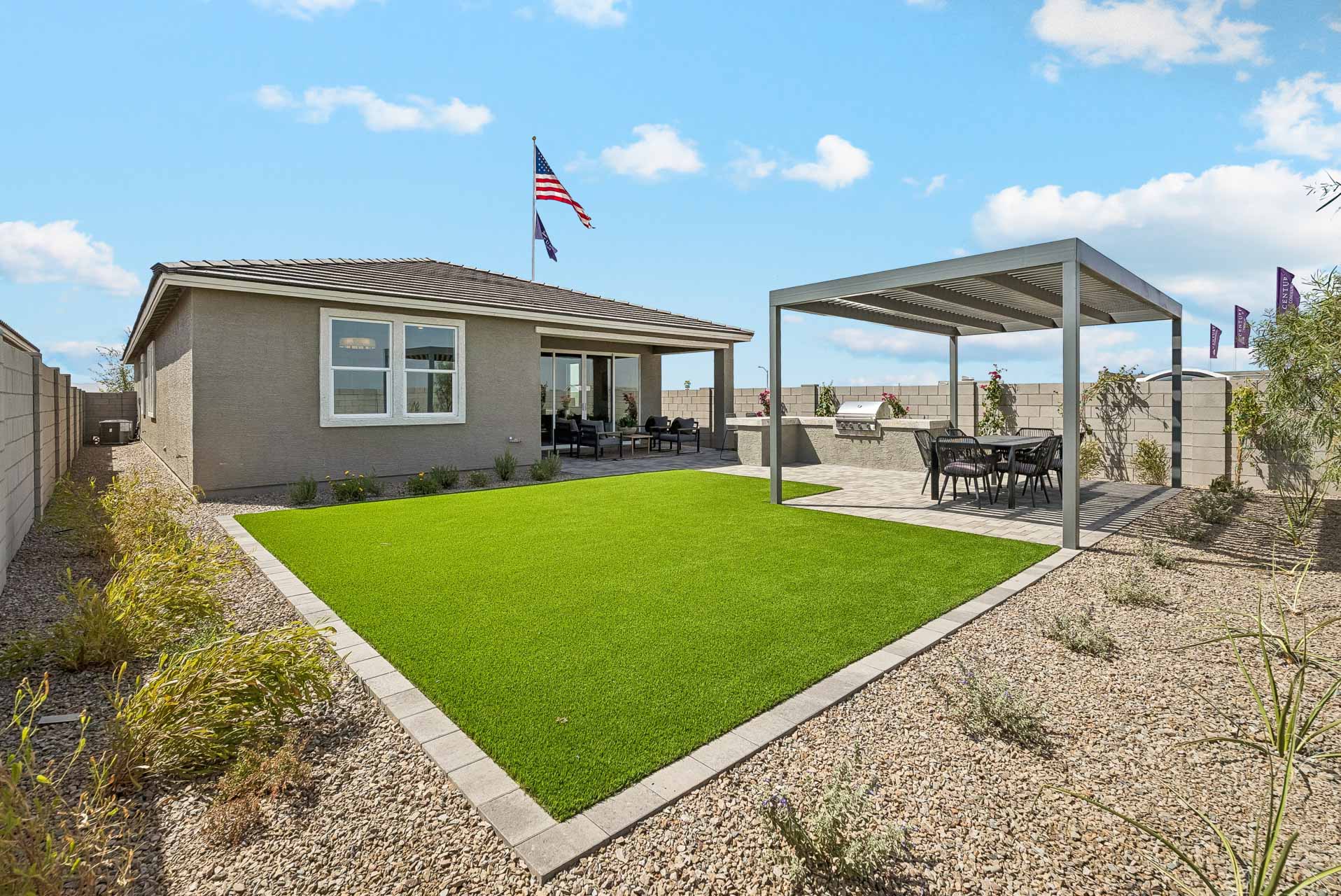 A building with a grass lawn and a flag on top.