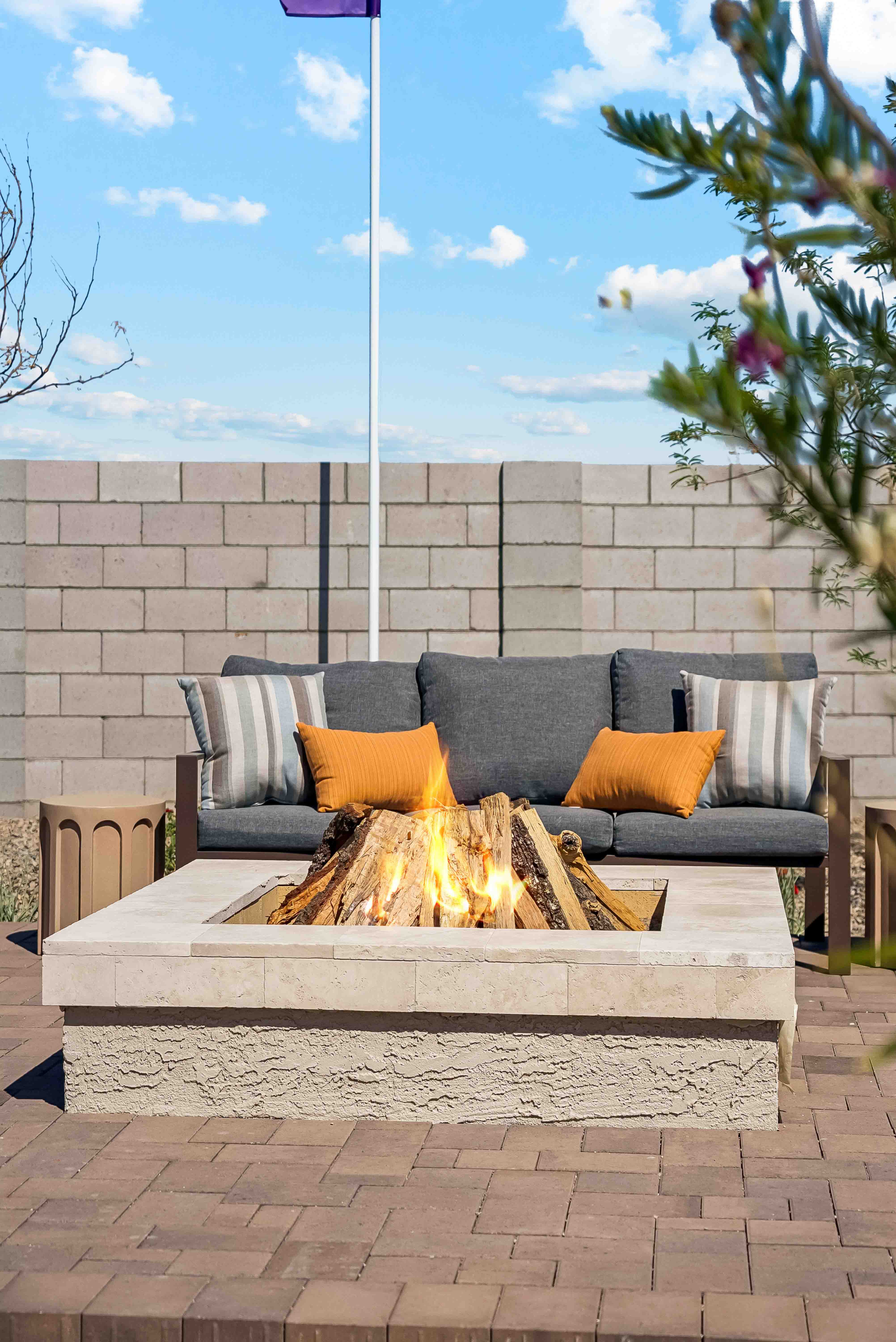 Editorial lifestyle photo detail shot of ceramic outdoor kitchen italian tile station with grill, table and chairs perfect for entertaining- new construction homes near Amarillo ranch palomino ranch in Maricopa AZ with USDA new construction