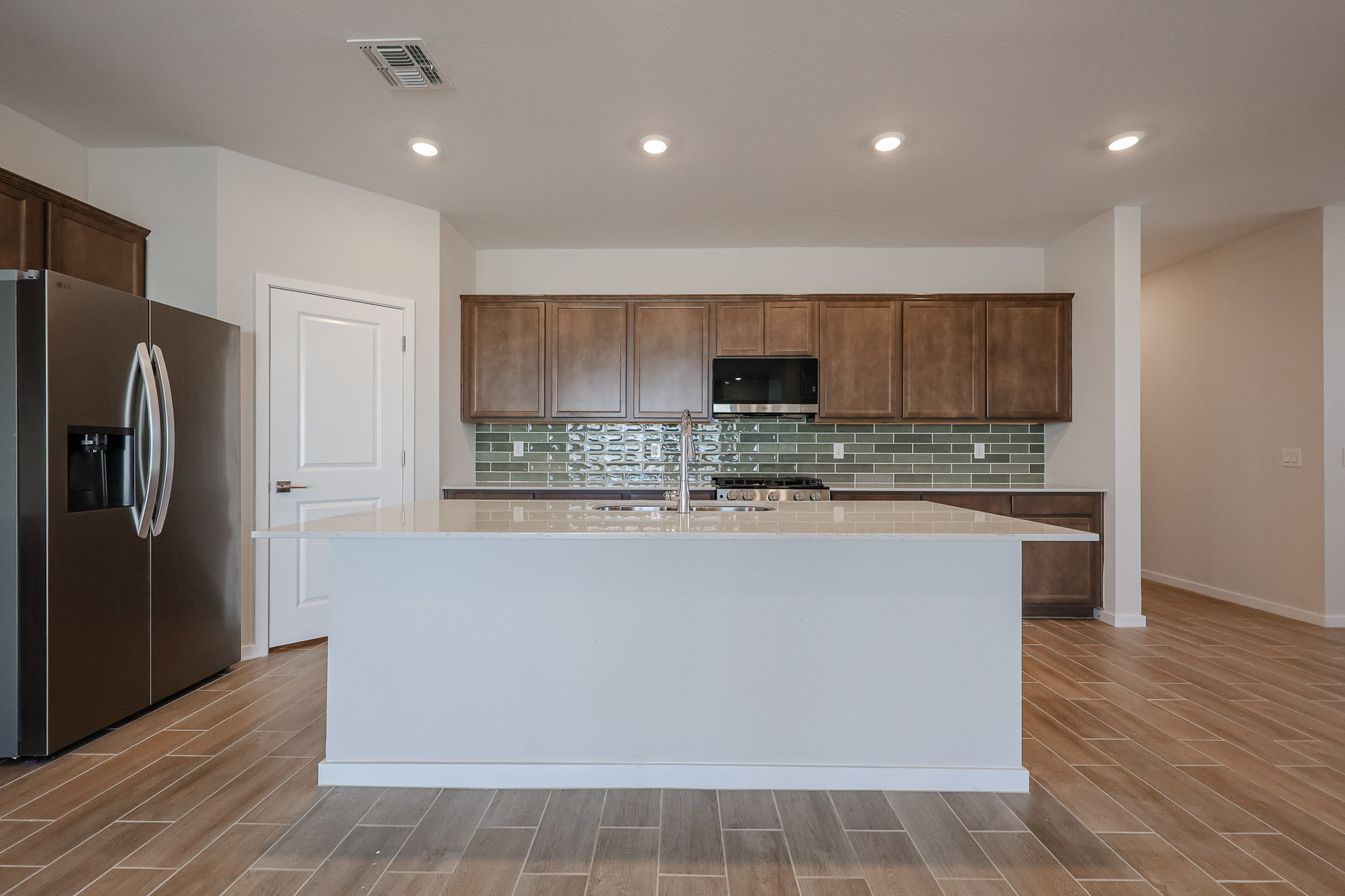 A kitchen with wooden cabinets.