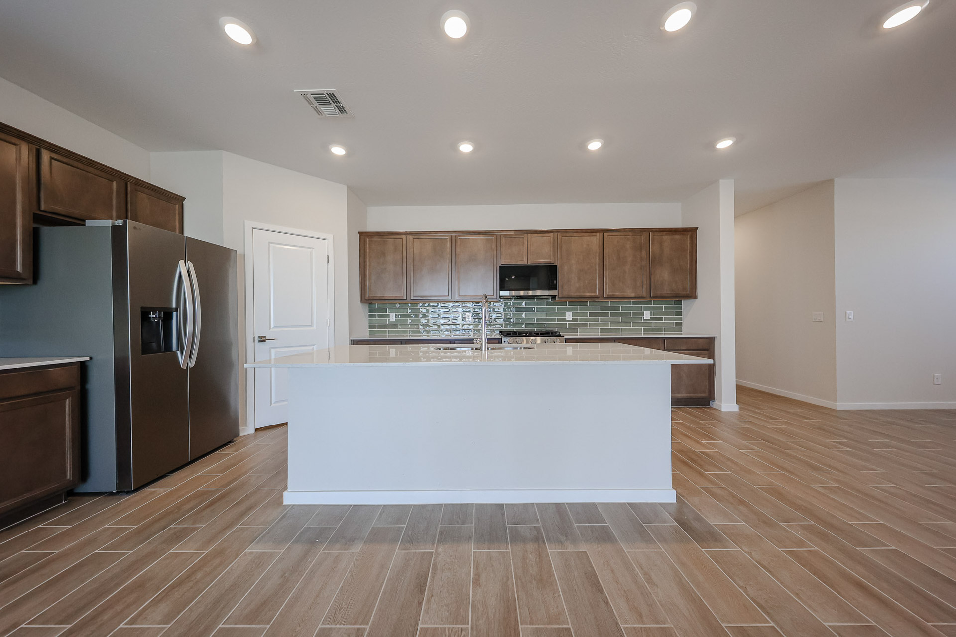 A kitchen with wooden cabinets.