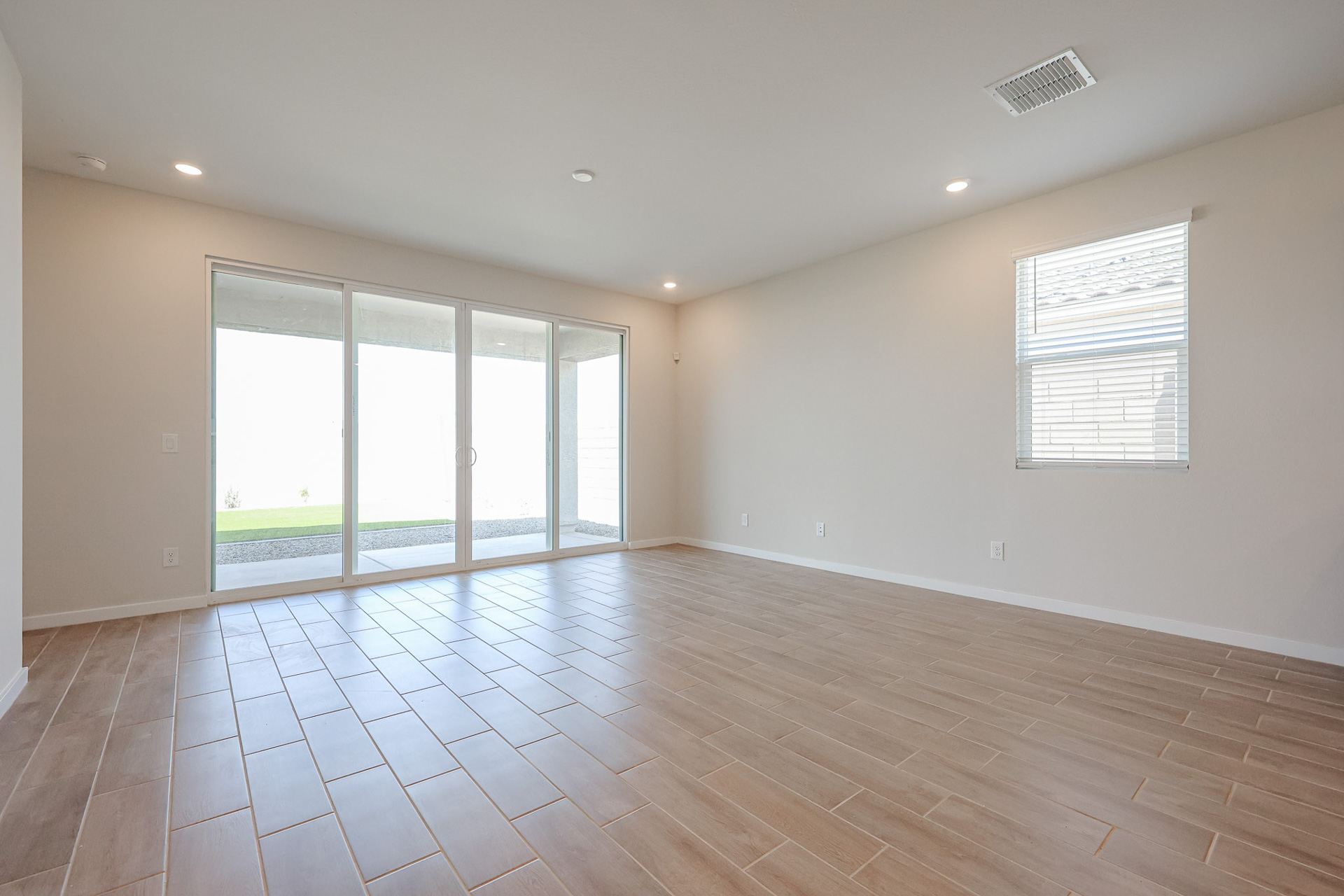 A room with a wood floor and windows.